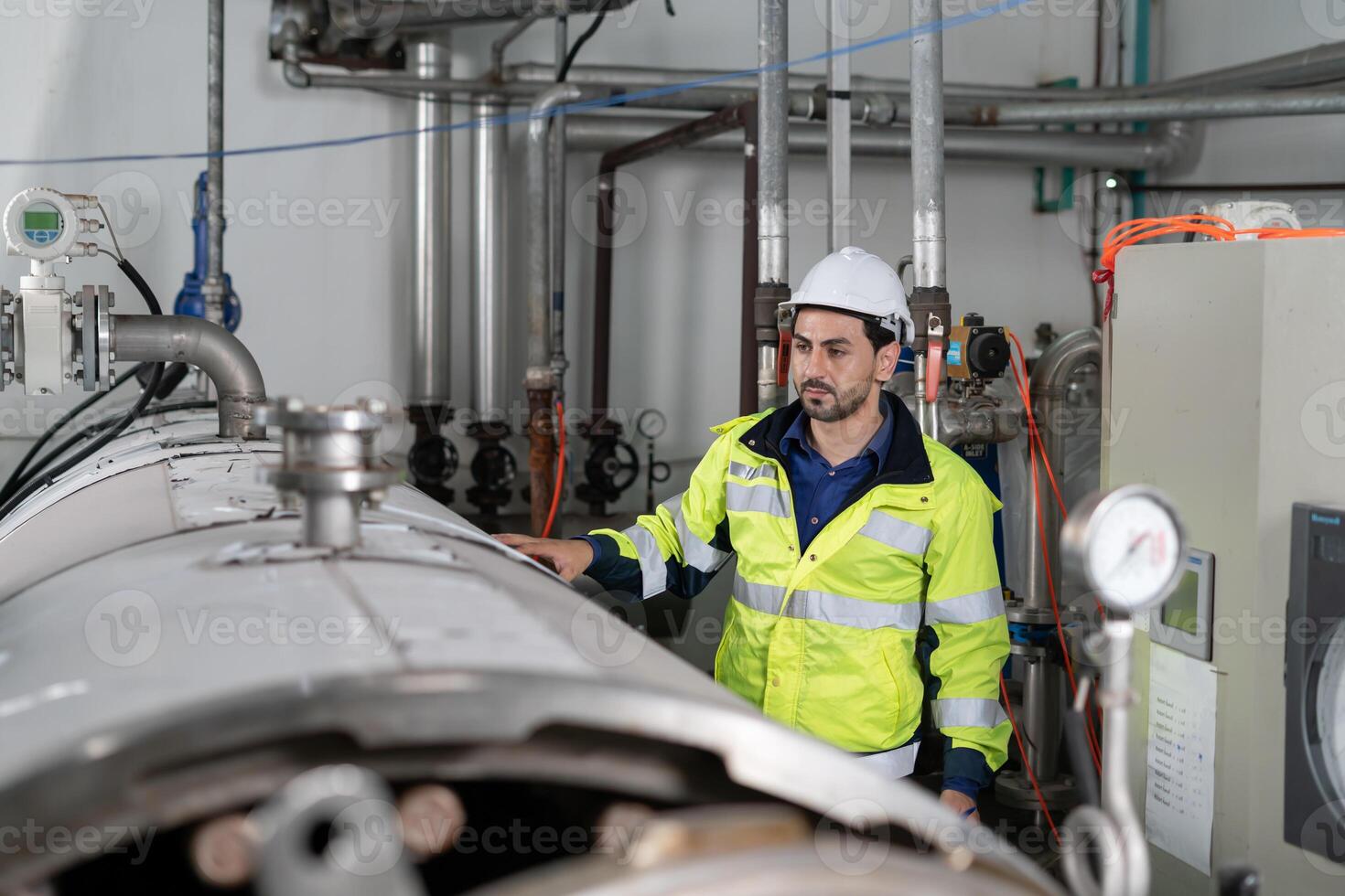 managers wearing safety helmet inspect the machines in the production line. The inspector opened the machine to test the system to meet the standard. machine maintenance photo