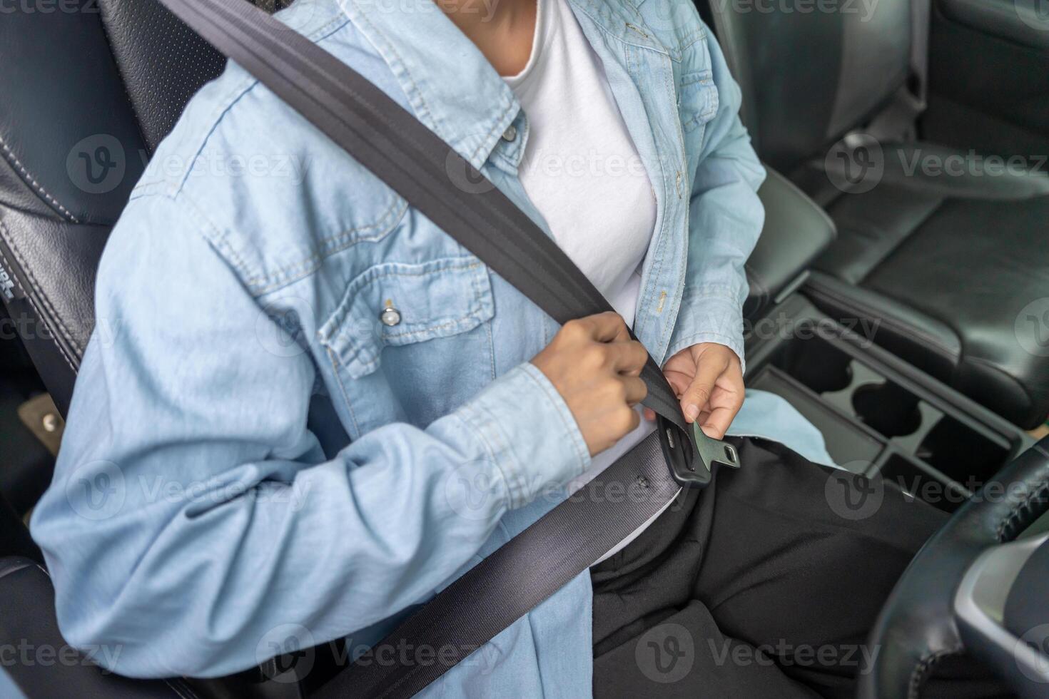 Woman use seatbelt and drives with intent, safe driving, driving practice, cheerful woman sits comfortably in the driver's seat with her hand confidently , readiness for a journey. photo
