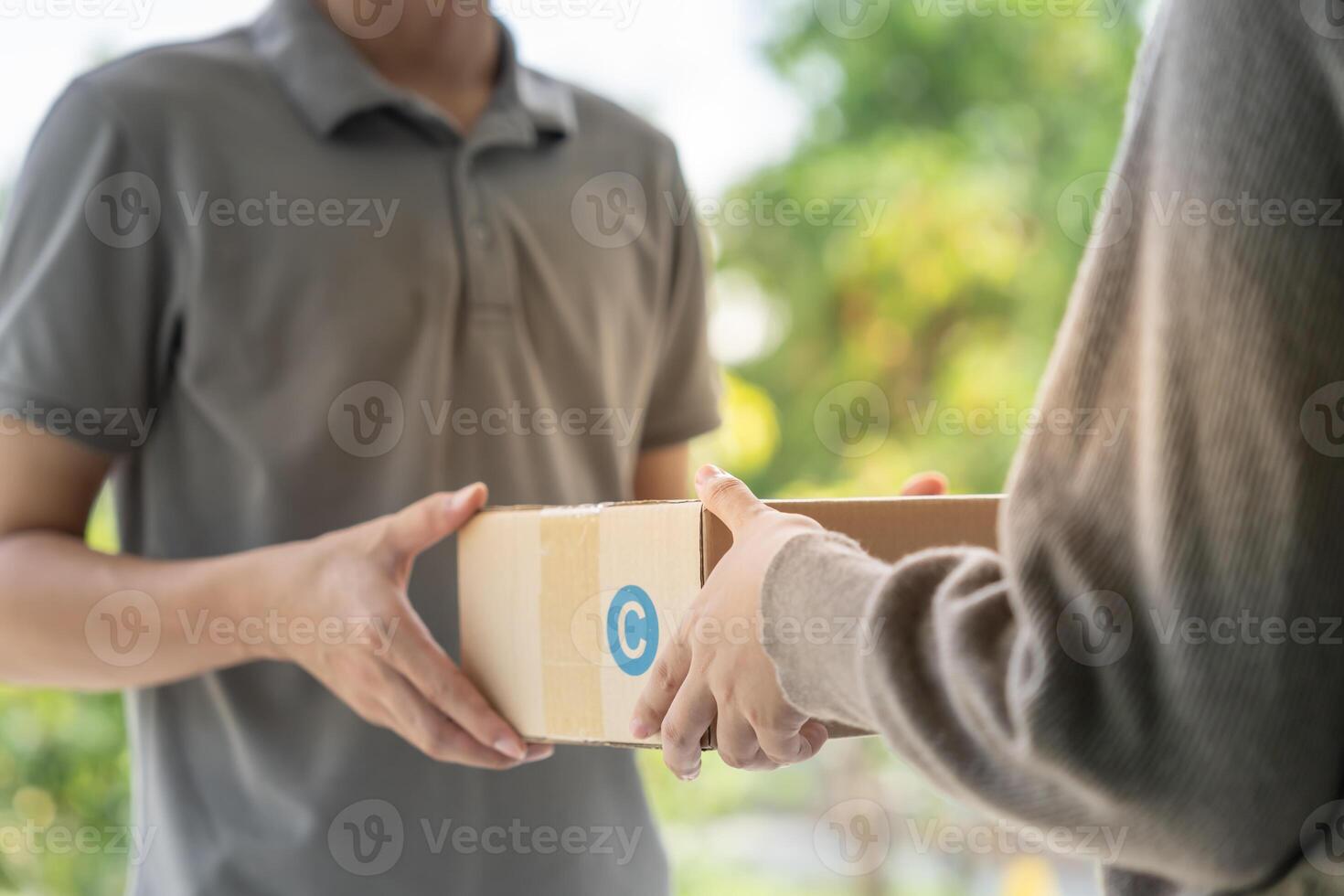 woman receive boxes parcel from courier in front house. Delivery man send deliver express. online shopping, paper containers, takeaway, postman, delivery service, packages photo