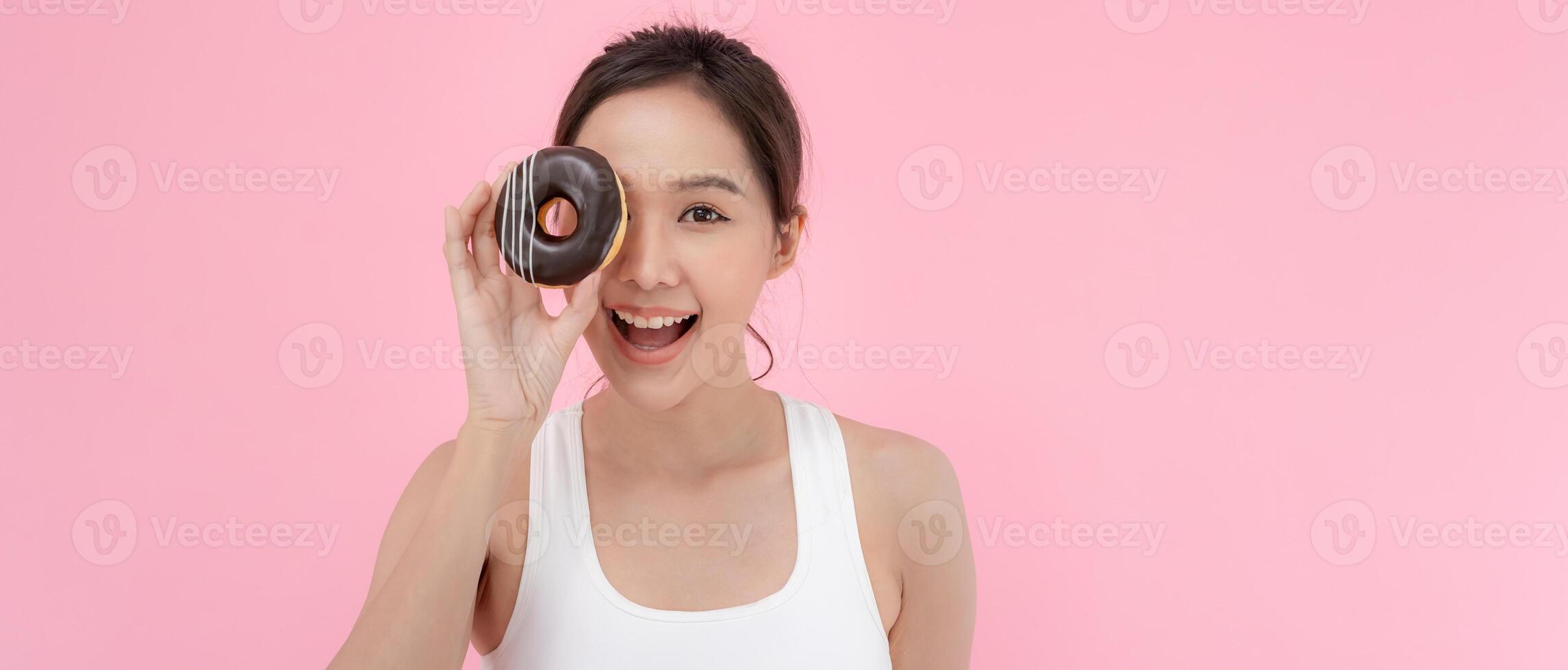 slim body asian women happy will eat donut after diet long time. very bored diet food, dieting female choose low calories food for diet. Good healthy food. weight lose, balance, control photo