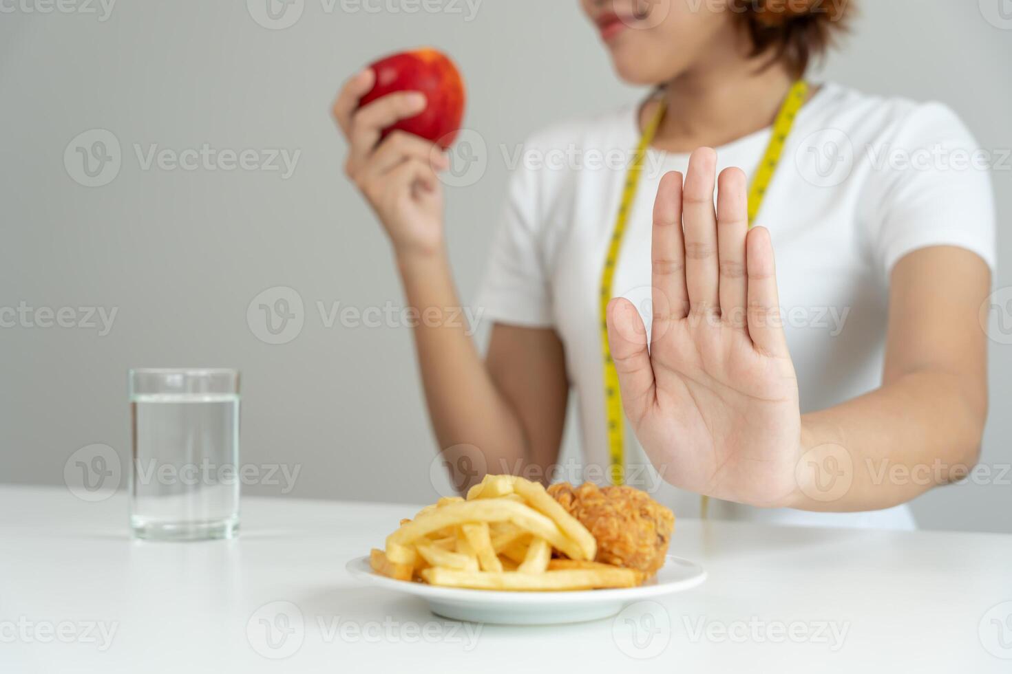 Beauty slim female body confuse French fries and fried chicken. Woman in restaurant achieves weight loss goal for healthy life, crazy about thinness, thin waist, nutritionist. Diet body shape. photo