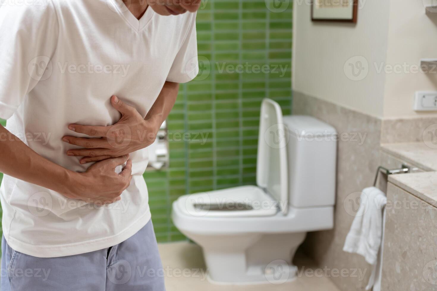 Constipation and diarrhea in bathroom. Hurt man touch belly stomach ache painful. colon inflammation problem, toxic food, abdominal pain, abdomen, constipated in toilet, stomachache. photo
