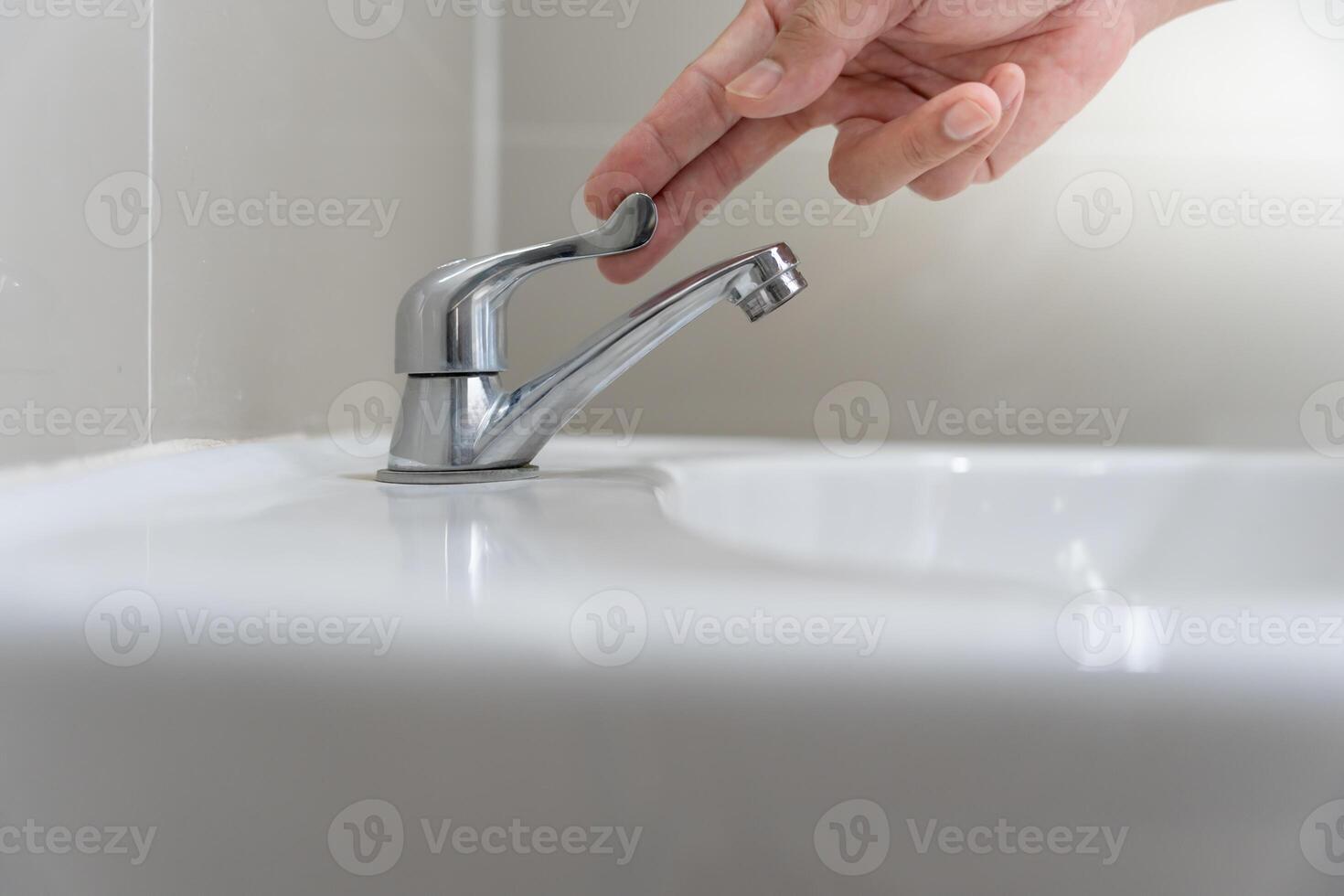Save water. Volunteer keeps turning off the running water in the bathroom to protect environment. Greening planet, reduce global warming, Save world, life, future, risk energy, crisis, water day photo