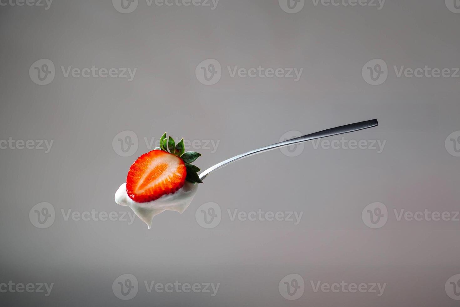 A spoon with a strawberry on it photo