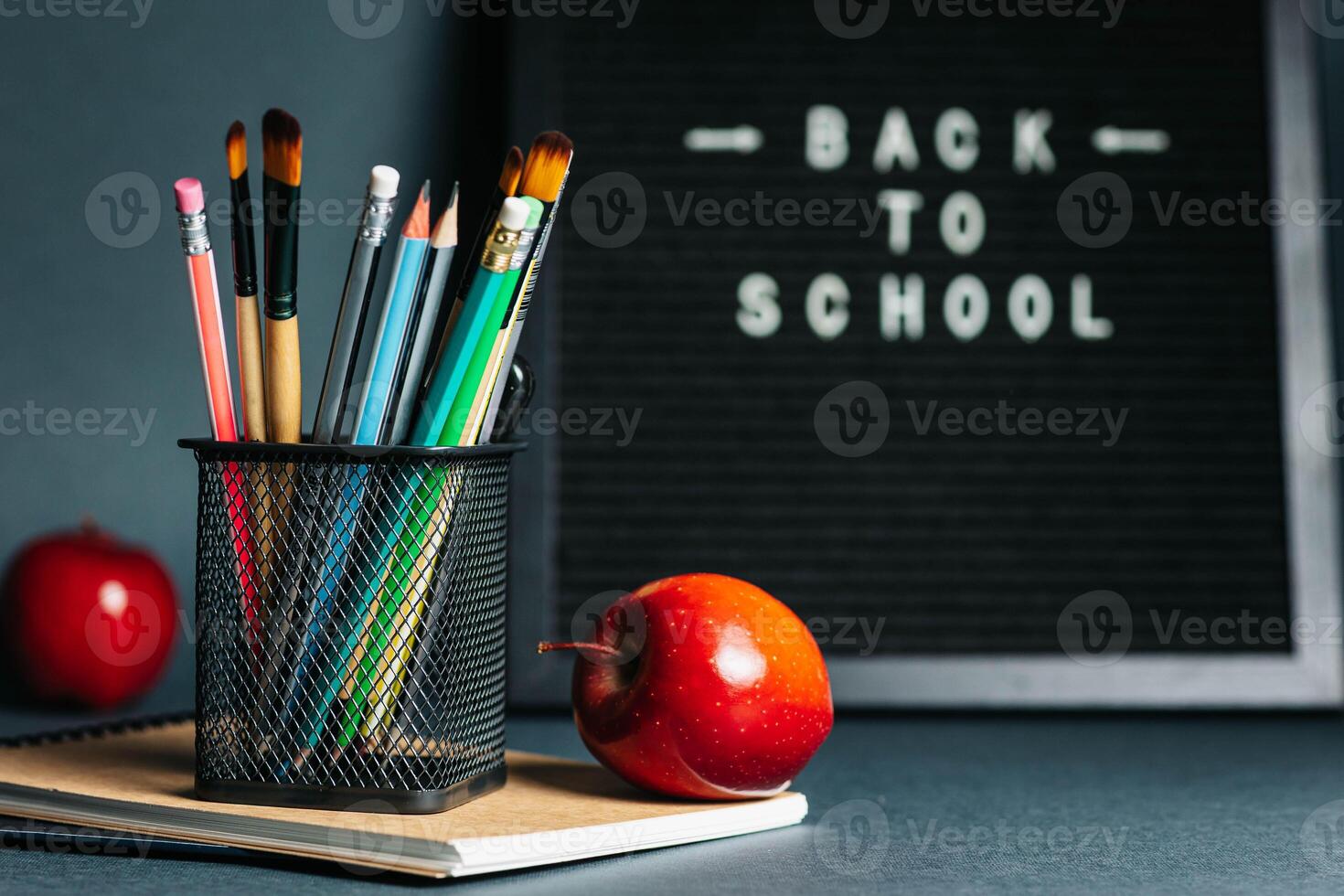 Back to School Concept with Blackboard, Pencils and Apples photo