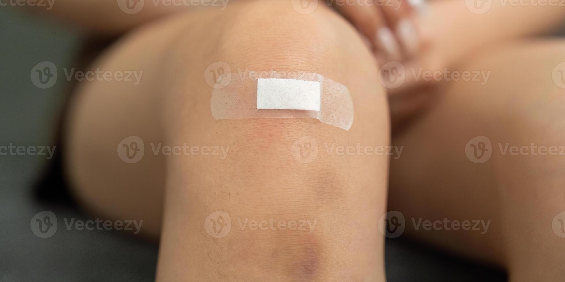 Injury Care. Close-up of a knee with a bandage applied for protection. photo