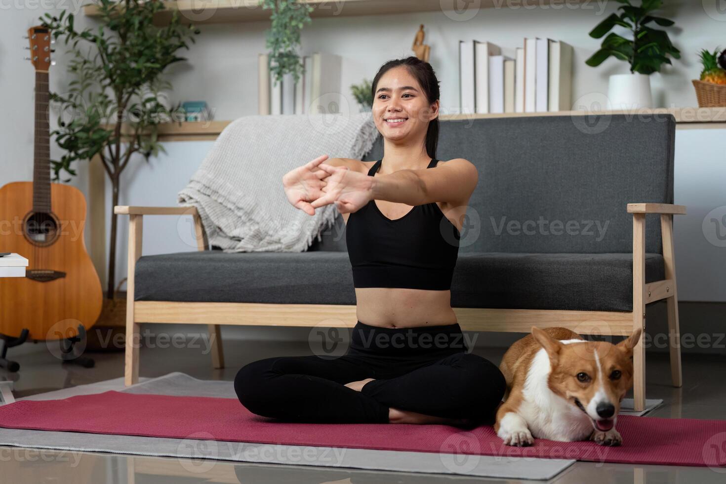 Yoga and Companionship. Young woman meditating with her dog in a peaceful home setting. photo