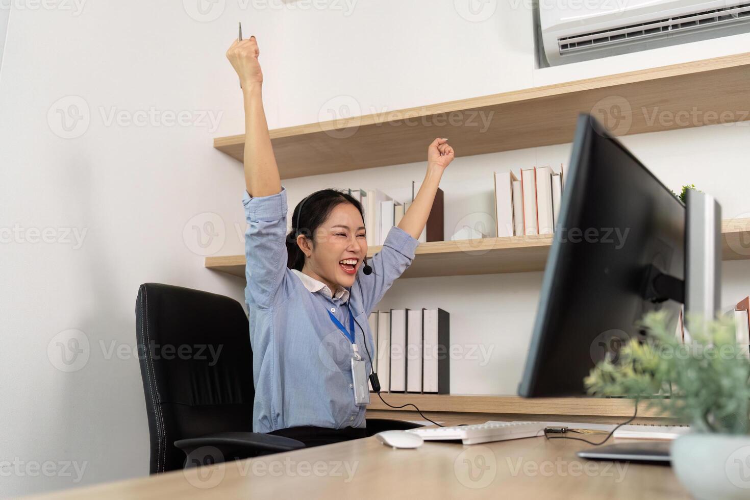 Excited Customer Service Agent. Female representative celebrating success after resolving client issues. photo