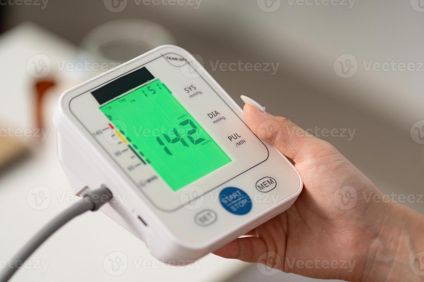 Health Monitoring. Individual checking blood pressure with digital monitor at home. photo