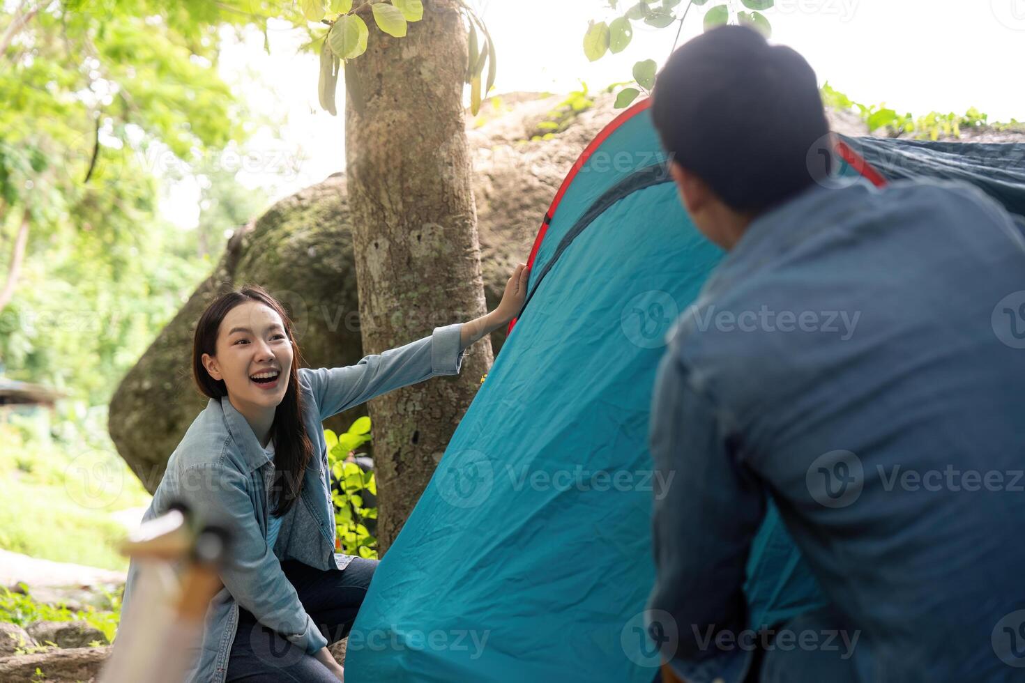 Couple Setting Up Tent Together While Camping in Nature photo