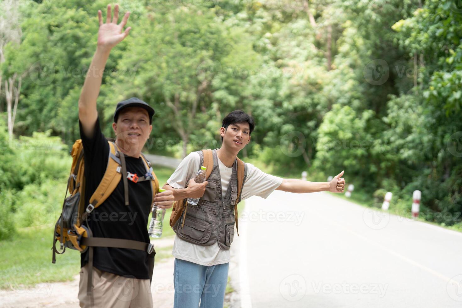 Father and Son on Hiking Trip. Two men waving and enjoying their outdoor adventure. photo