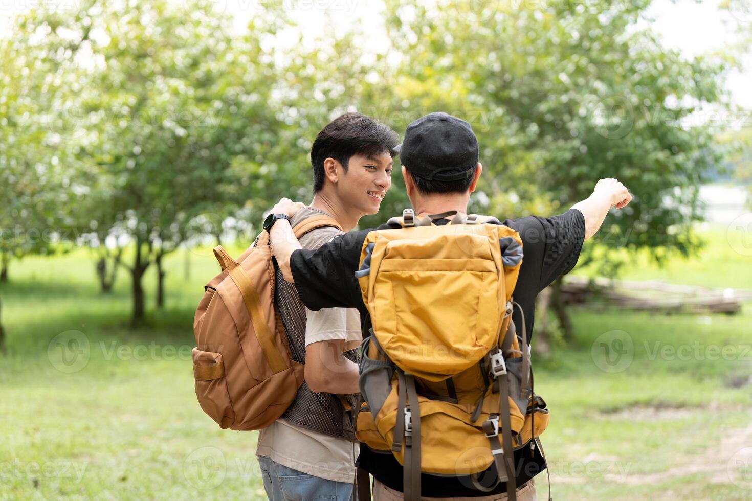 Father and Son Hiking Together. A father guiding his son during an outdoor adventure. photo