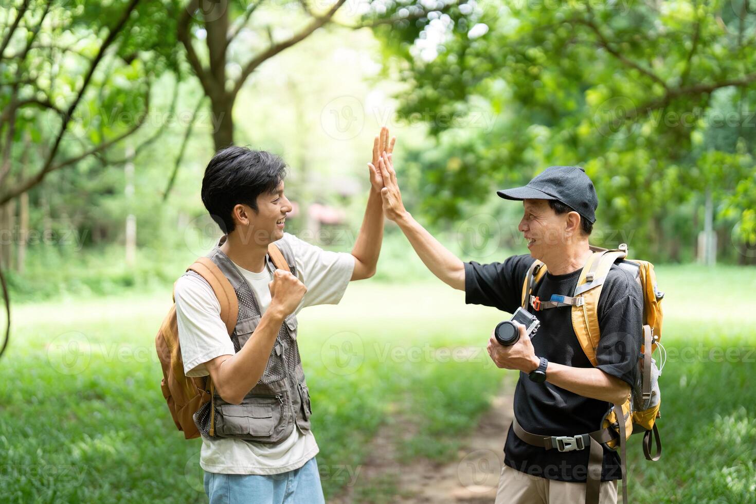 Father and Son Celebrating Together. A joyful moment shared between a father and son during their hike. photo