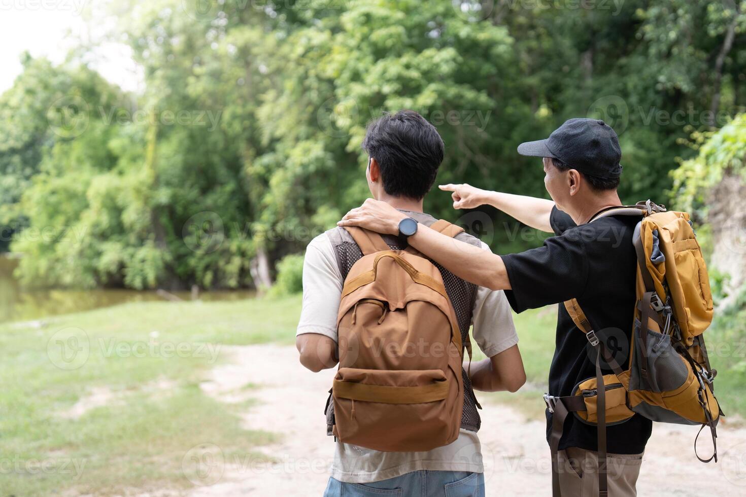 Father and Son Exploring Nature. Two men enjoying a scenic view while hiking. photo