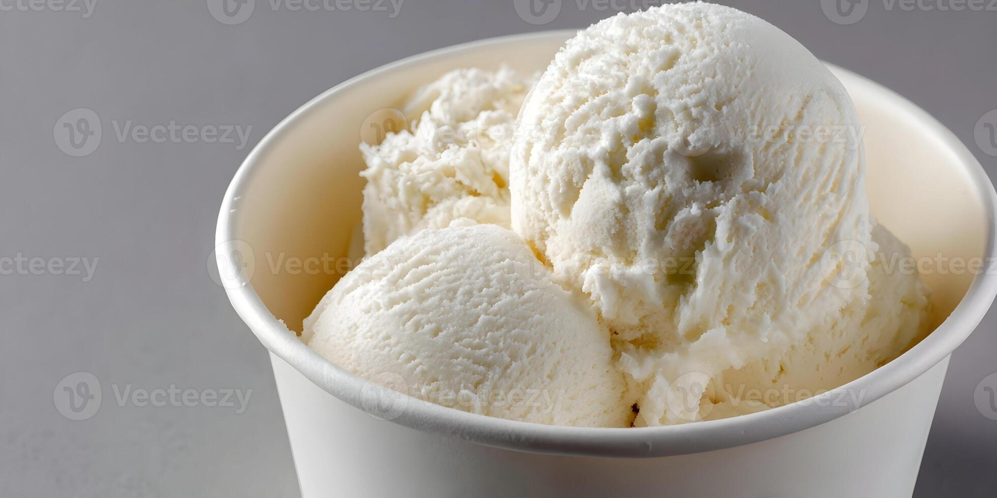 Closeup of Creamy Vanilla Ice Cream Scoops in Paper Cup photo