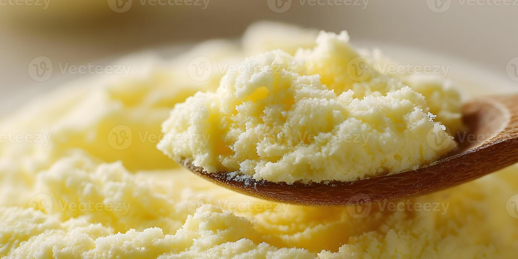 Closeup of Creamy Yellow Powder in Wooden Spoon Dairy Product Food Ingredient photo