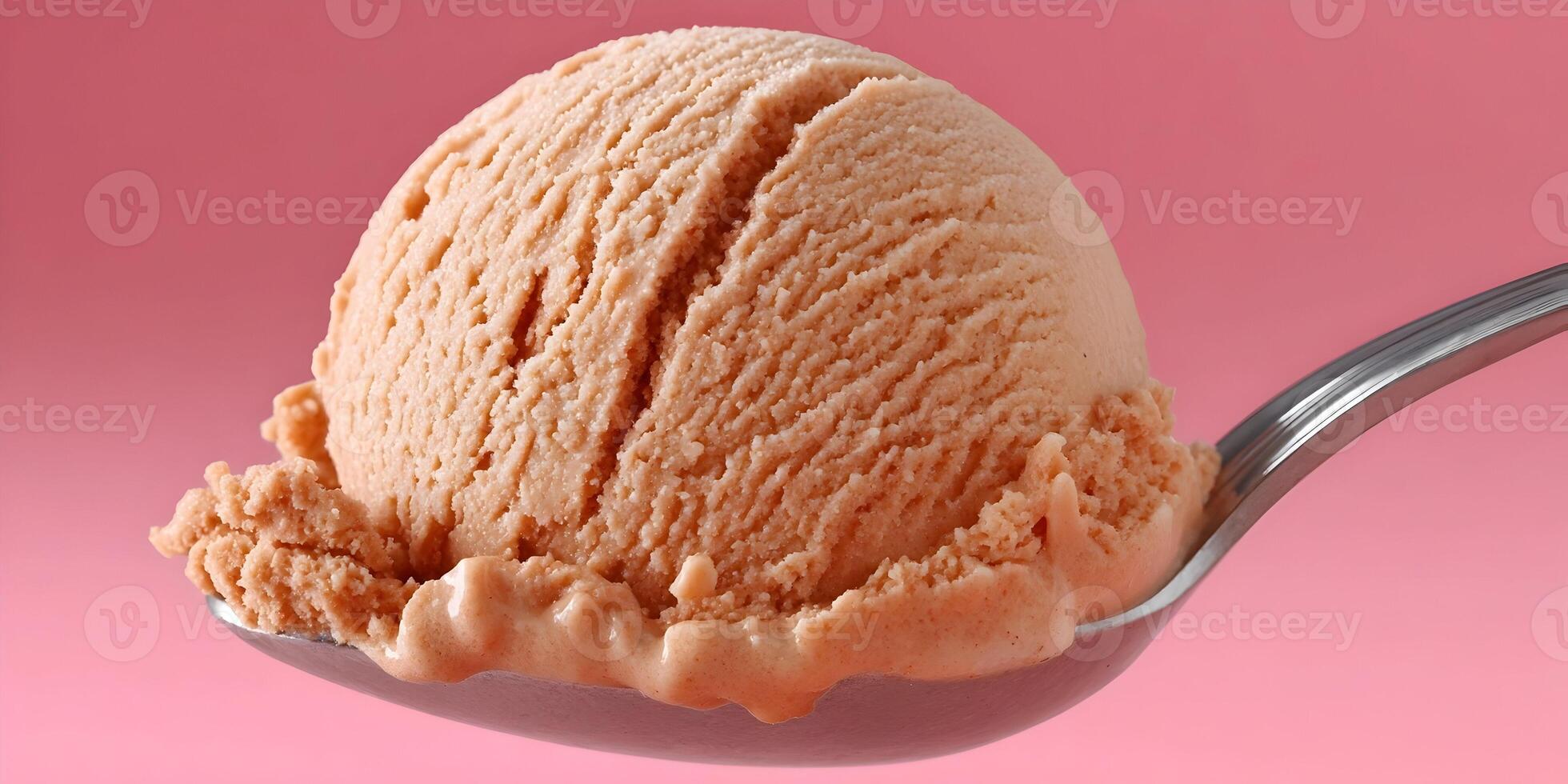 Closeup of a Single Scoop of Brown Ice Cream on a Spoon Pink Background photo