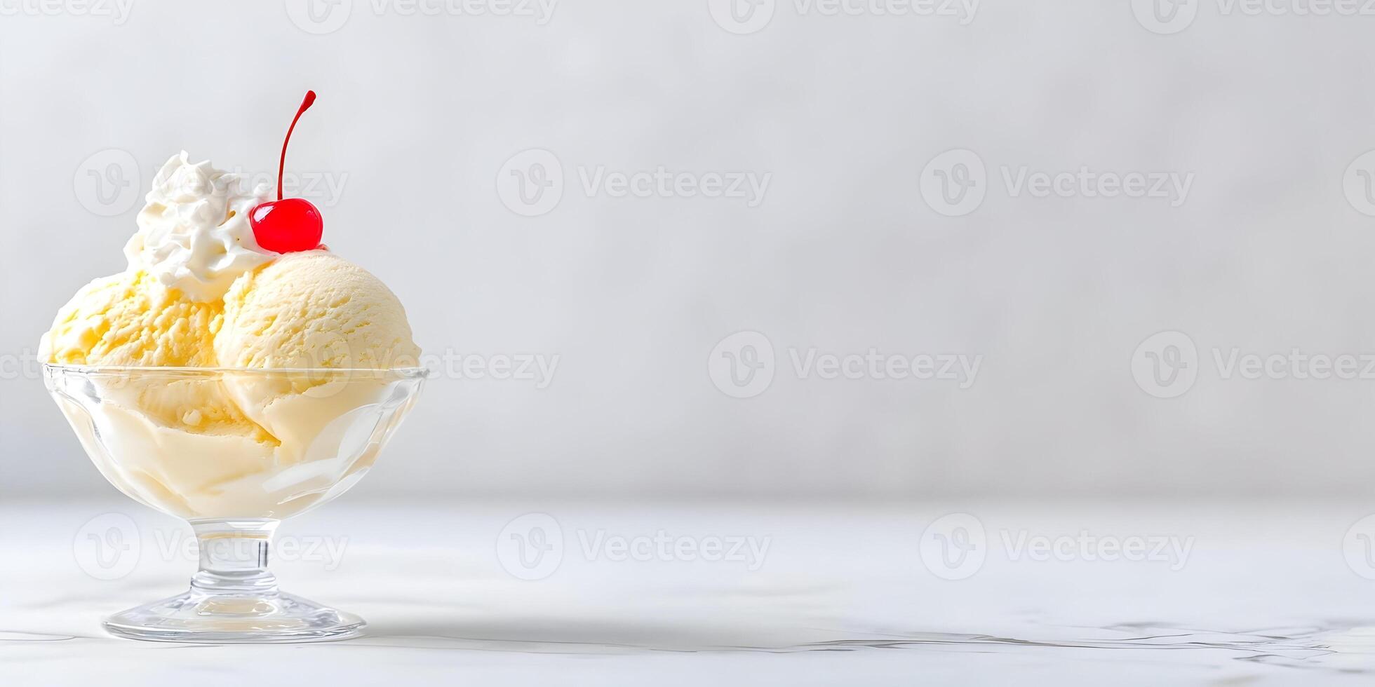 Vanilla Ice Cream Sundae with Whipped Cream and Cherry Garnish in Glass Bowl photo