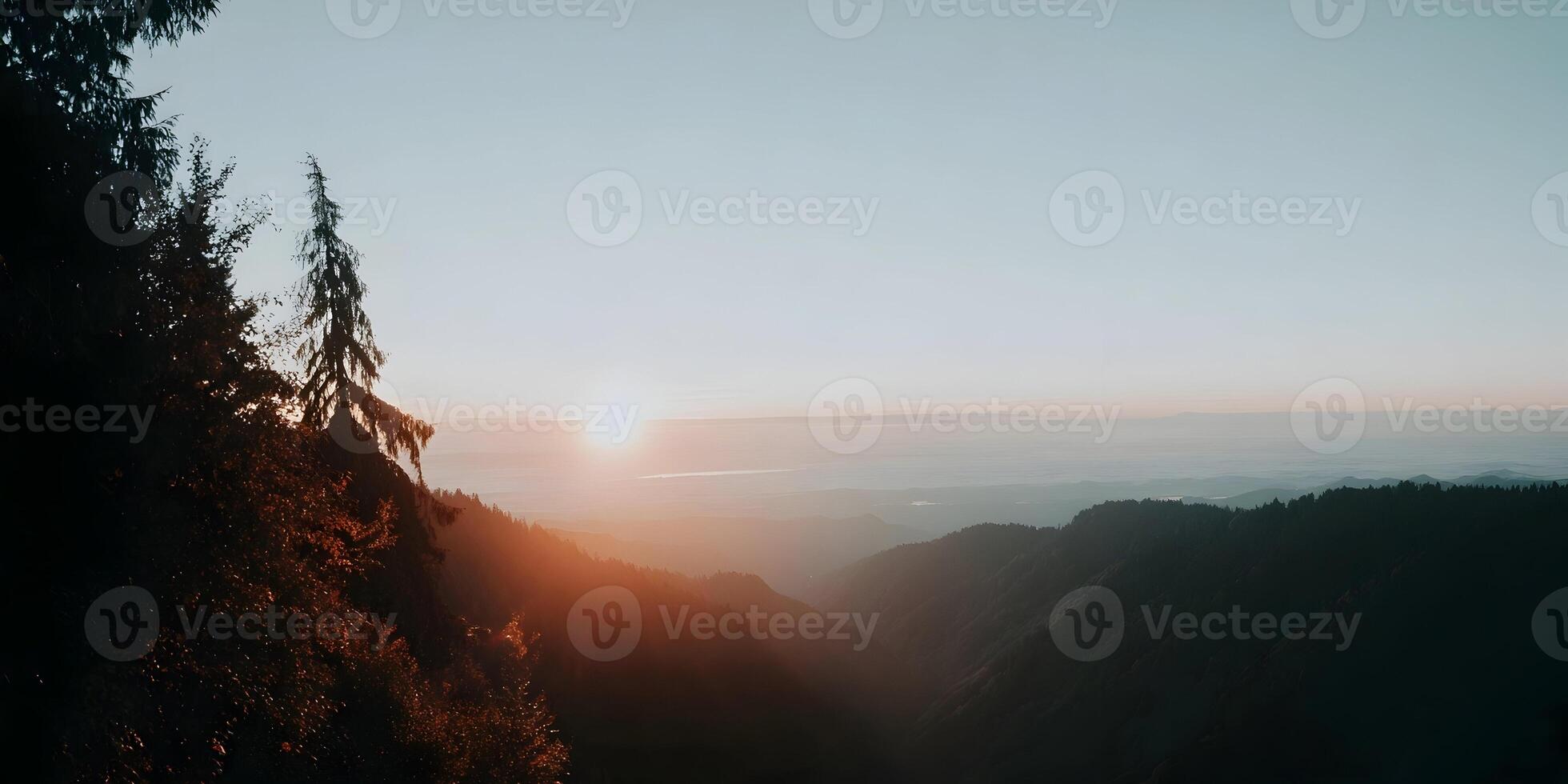 Sunrise Mountain Landscape View with Trees Silhouetted Against the Golden Light photo