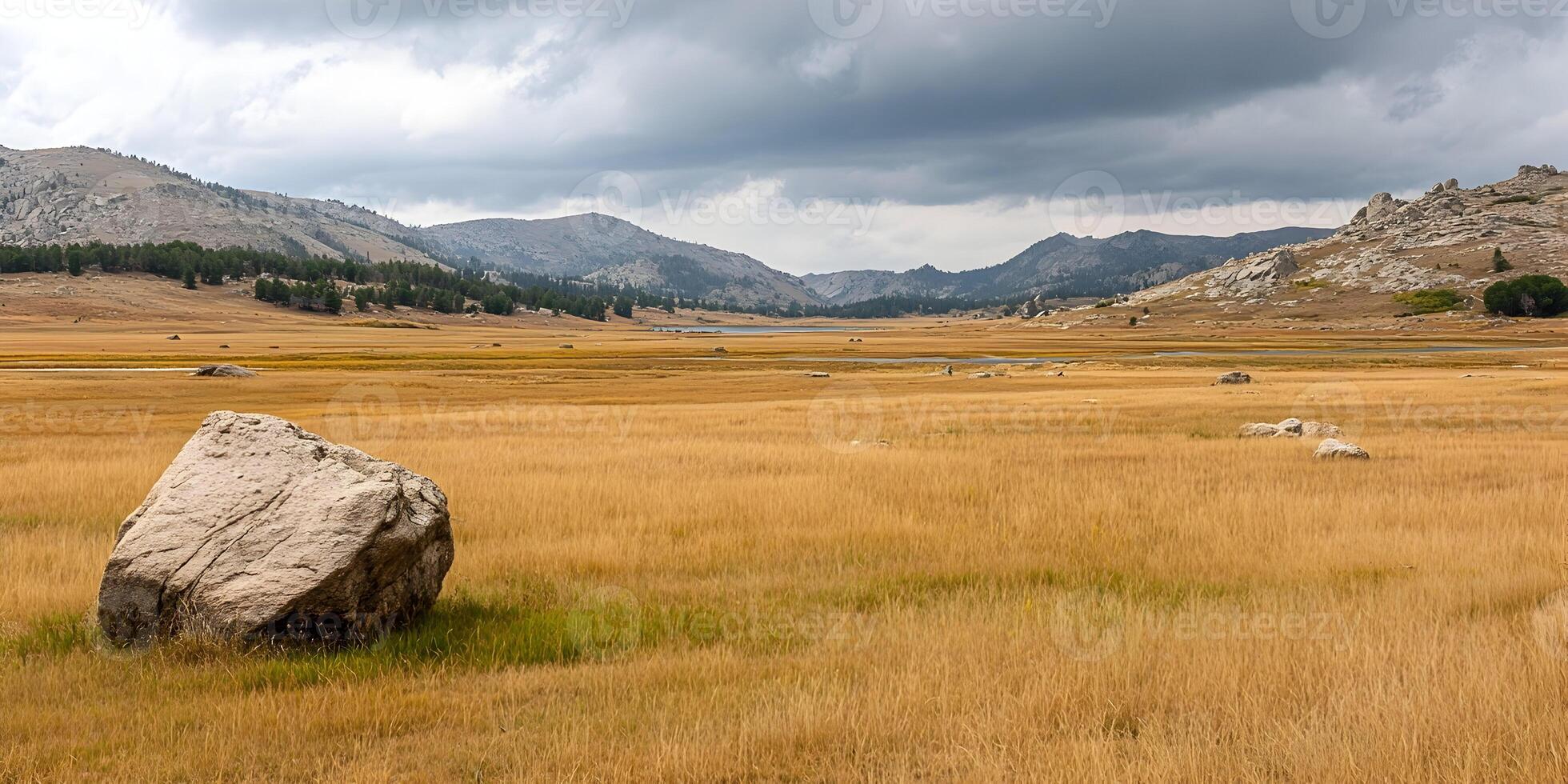 Autumnal Landscape Golden Grassland Mountains Stone Boulder Cloudy Sky photo