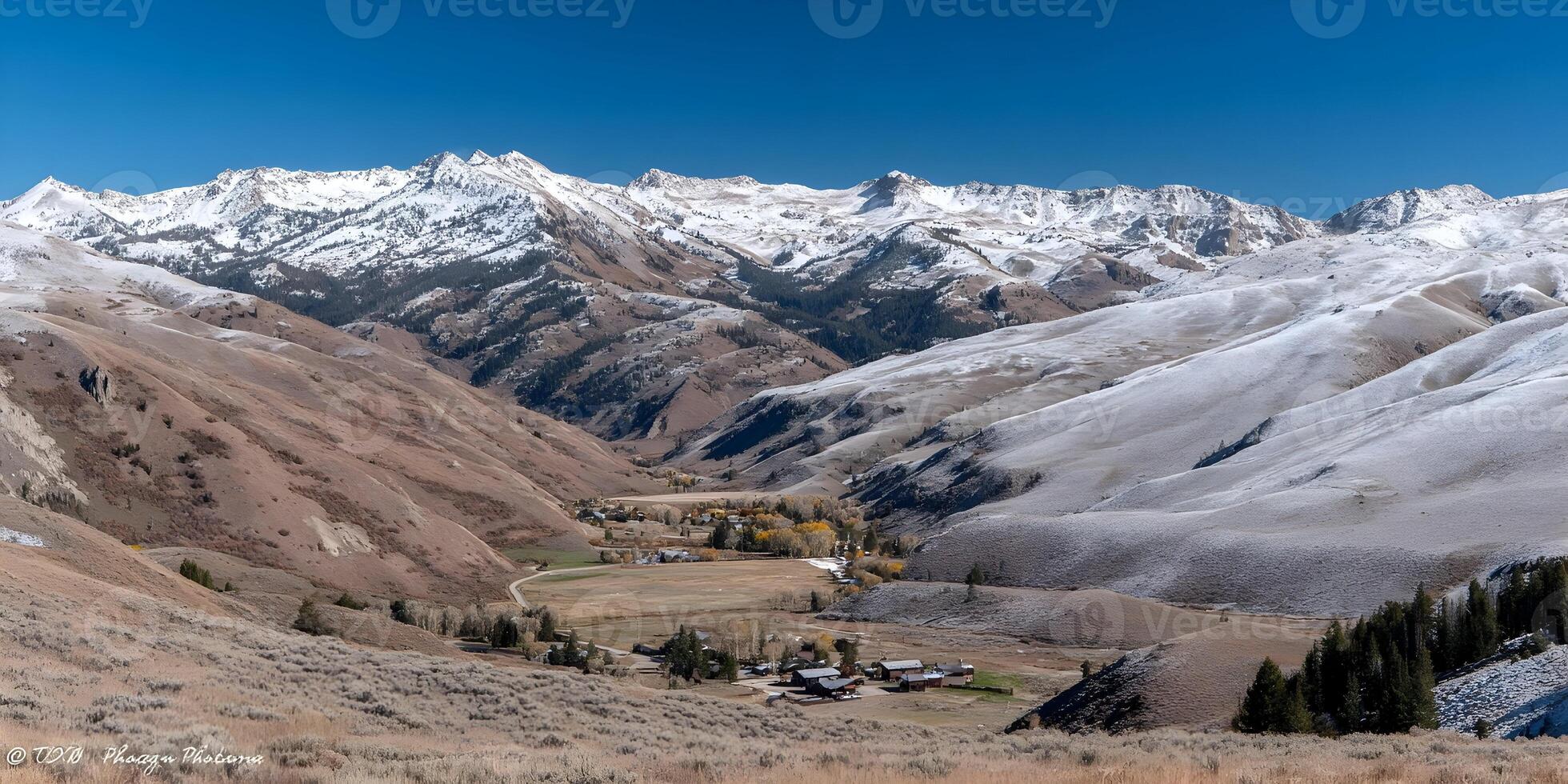 Snowy Mountain Range Landscape with Small Town Autumn Scenery photo
