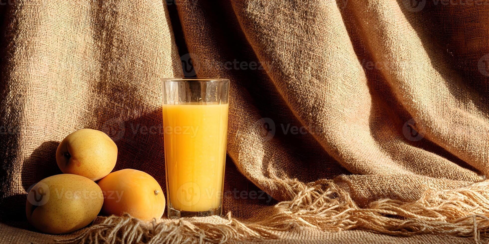 Glass of Orange Juice with Three Pears on Brown Fabric photo