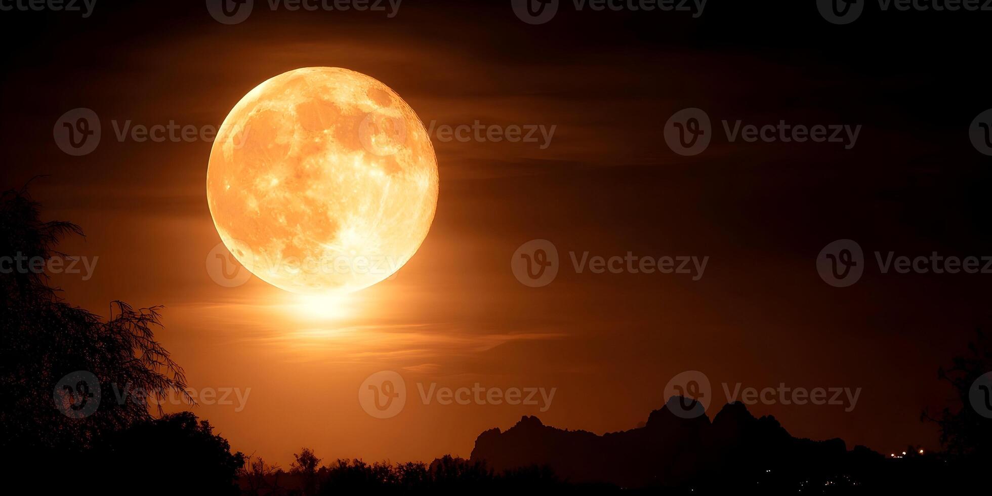 Large Orange Full Moon over Silhouetted Landscape at Night photo