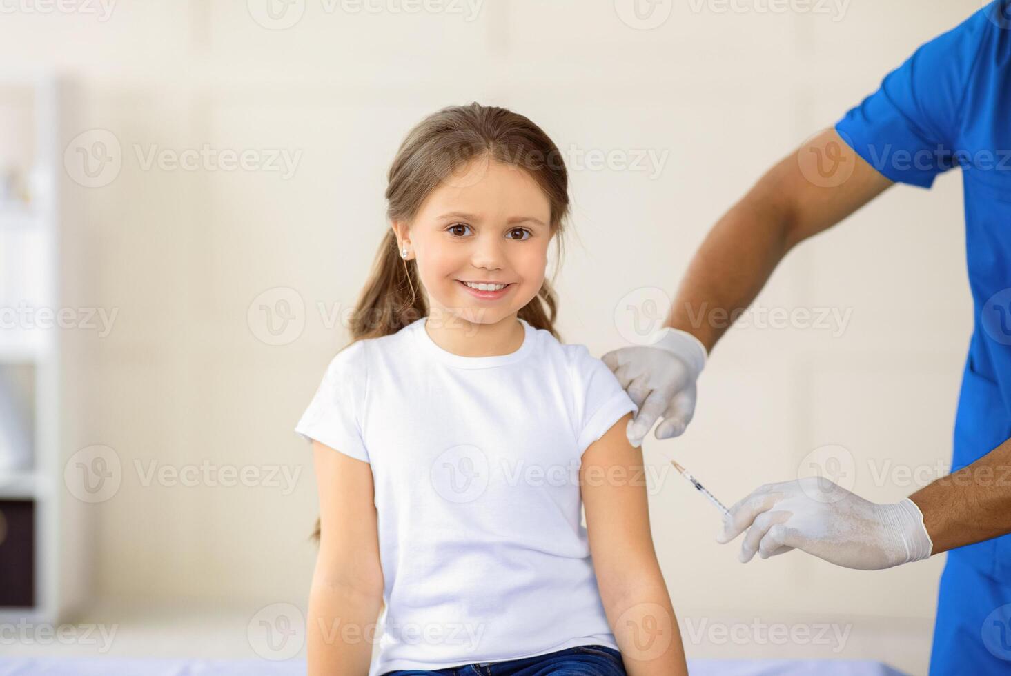 African American doctor making coronavirus vaccine injection to little girl at clinic, panorama. Positive child receiving covid-19 immunization at hospital. Protection against virus concept photo