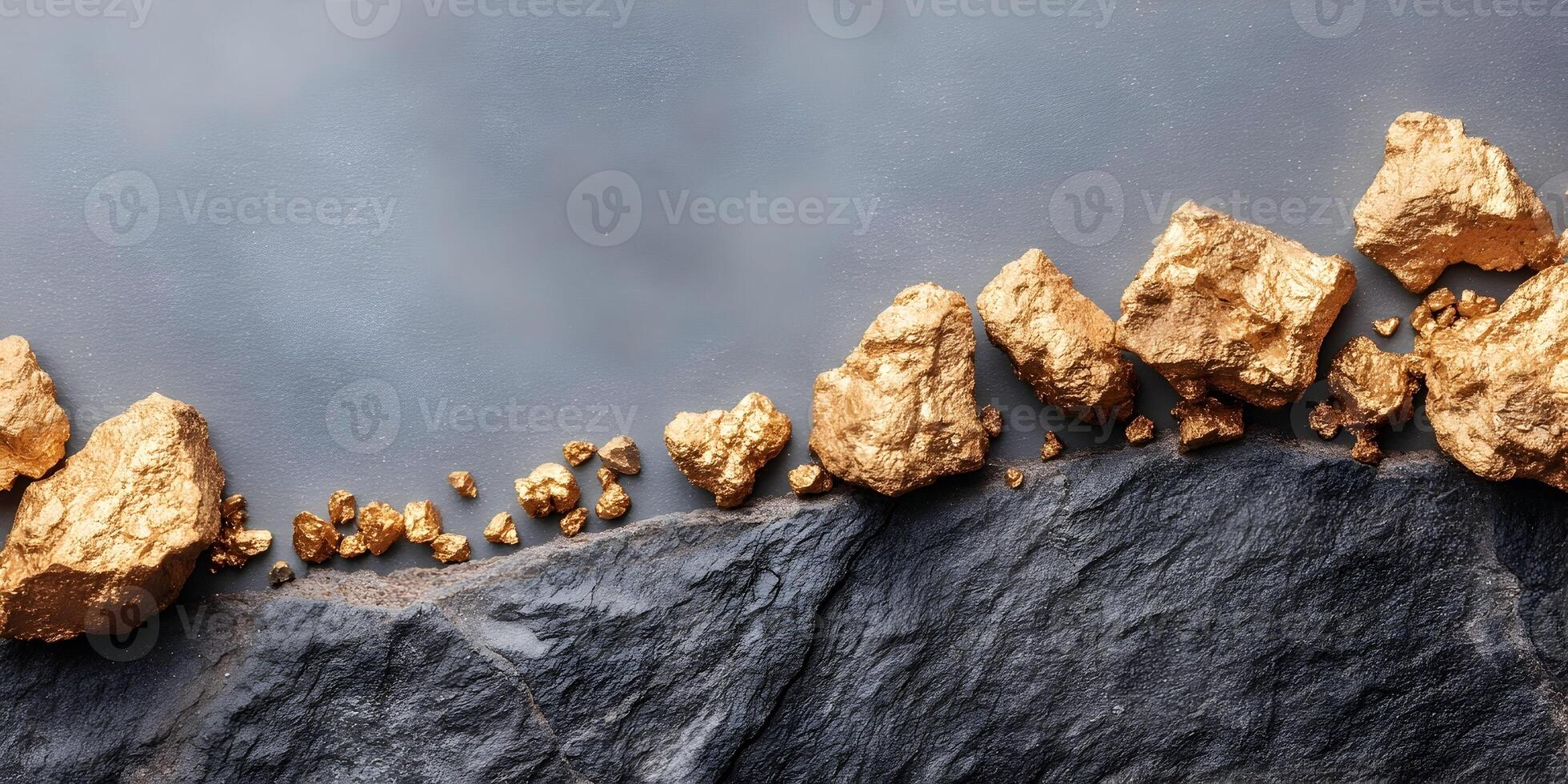 Gold Nugget Stones on Dark Gray Rock Surface photo