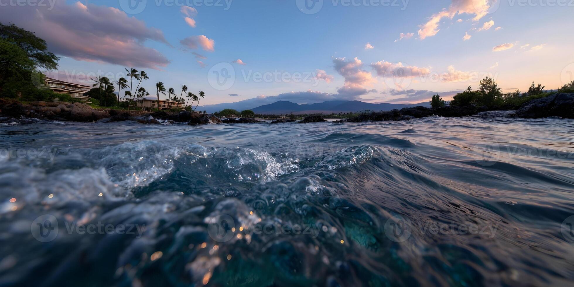 Ocean Waves Crashing on Rocky Shore with Palm Trees and Sunset Mountain View photo