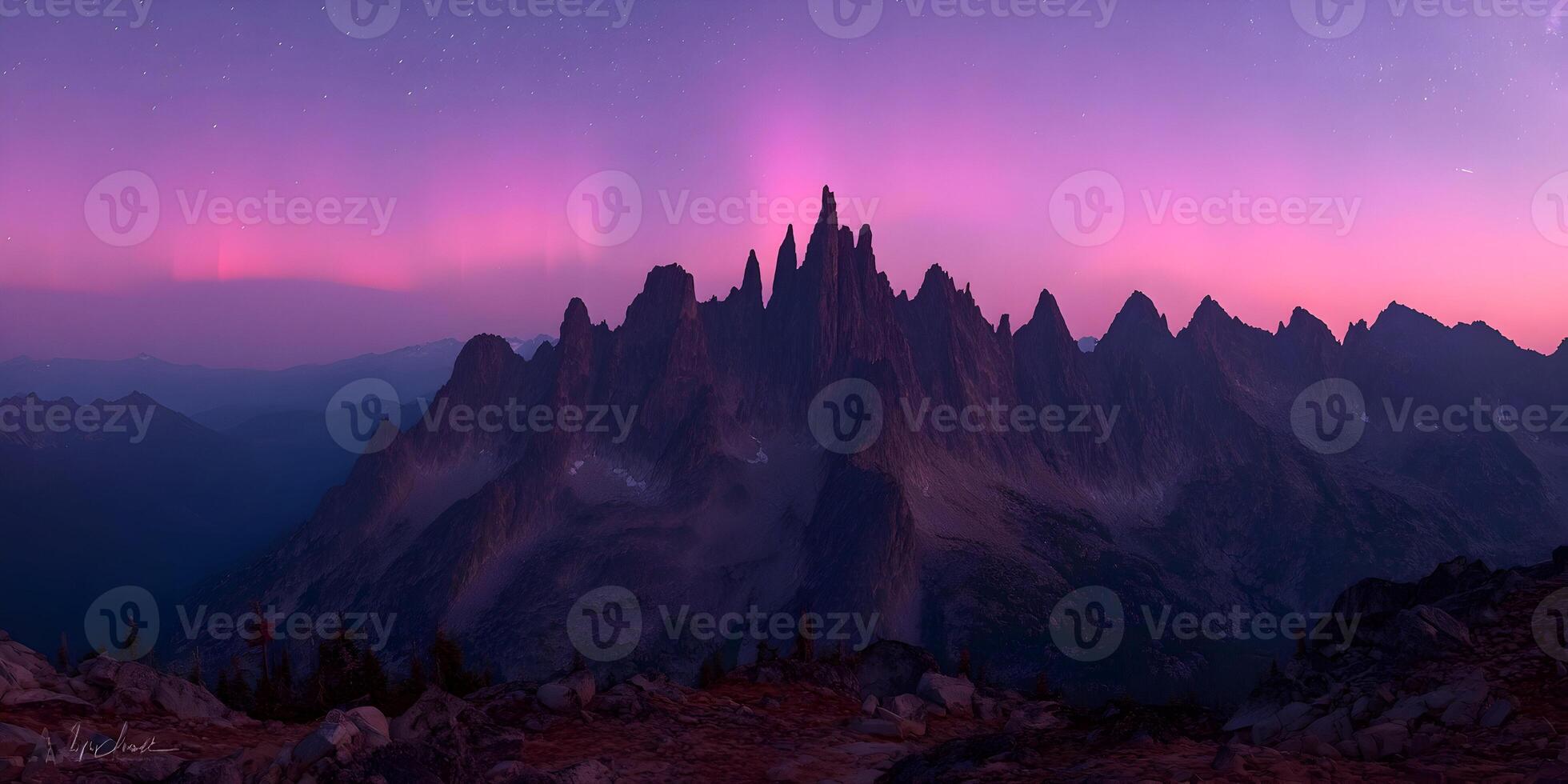 Majestic Mountain Range at Dusk with Pink Aurora Borealis photo