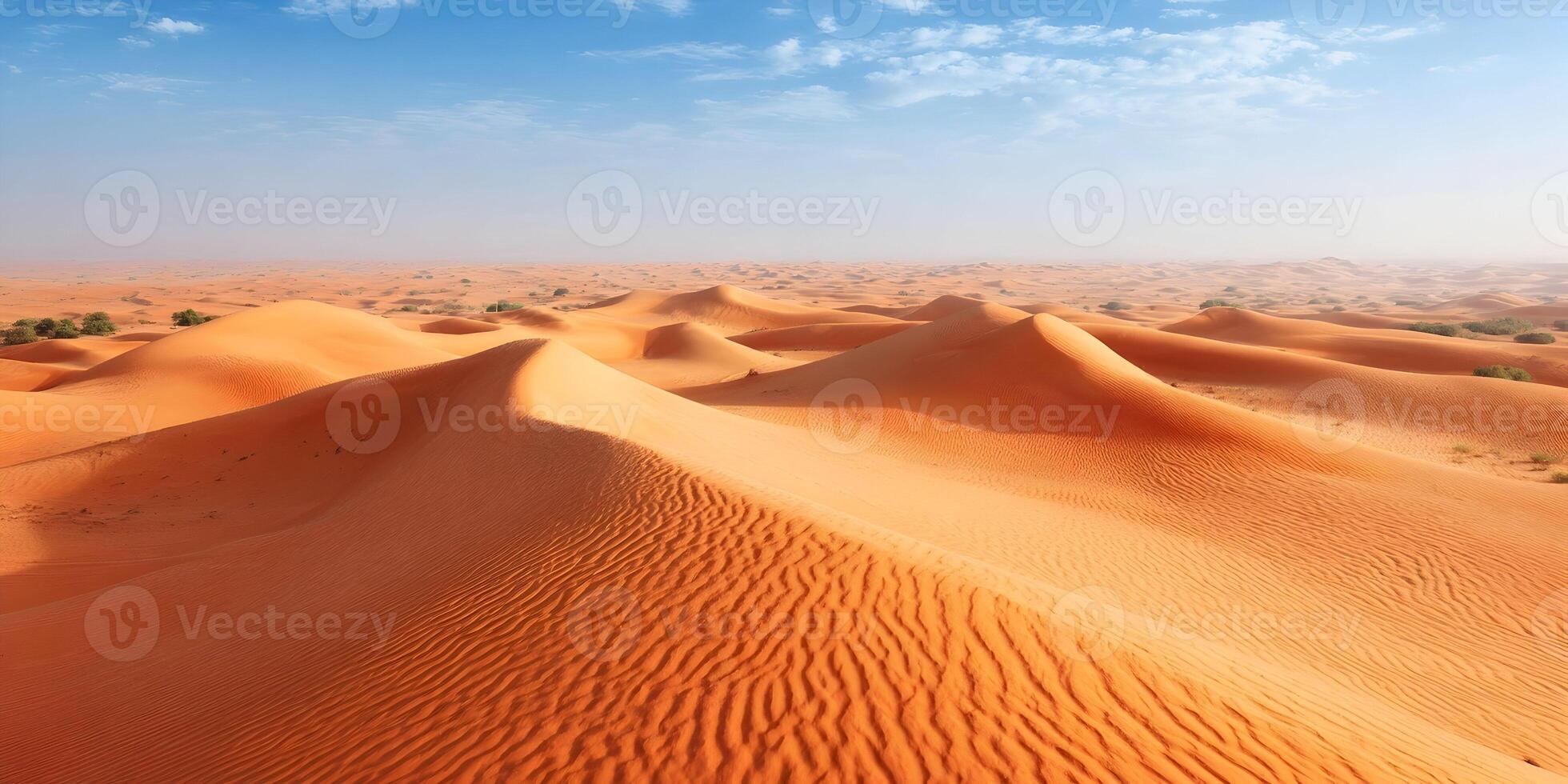 Stunning Aerial View of Rolling Orange Sand Dunes in Desert Landscape Under Blue Sky photo