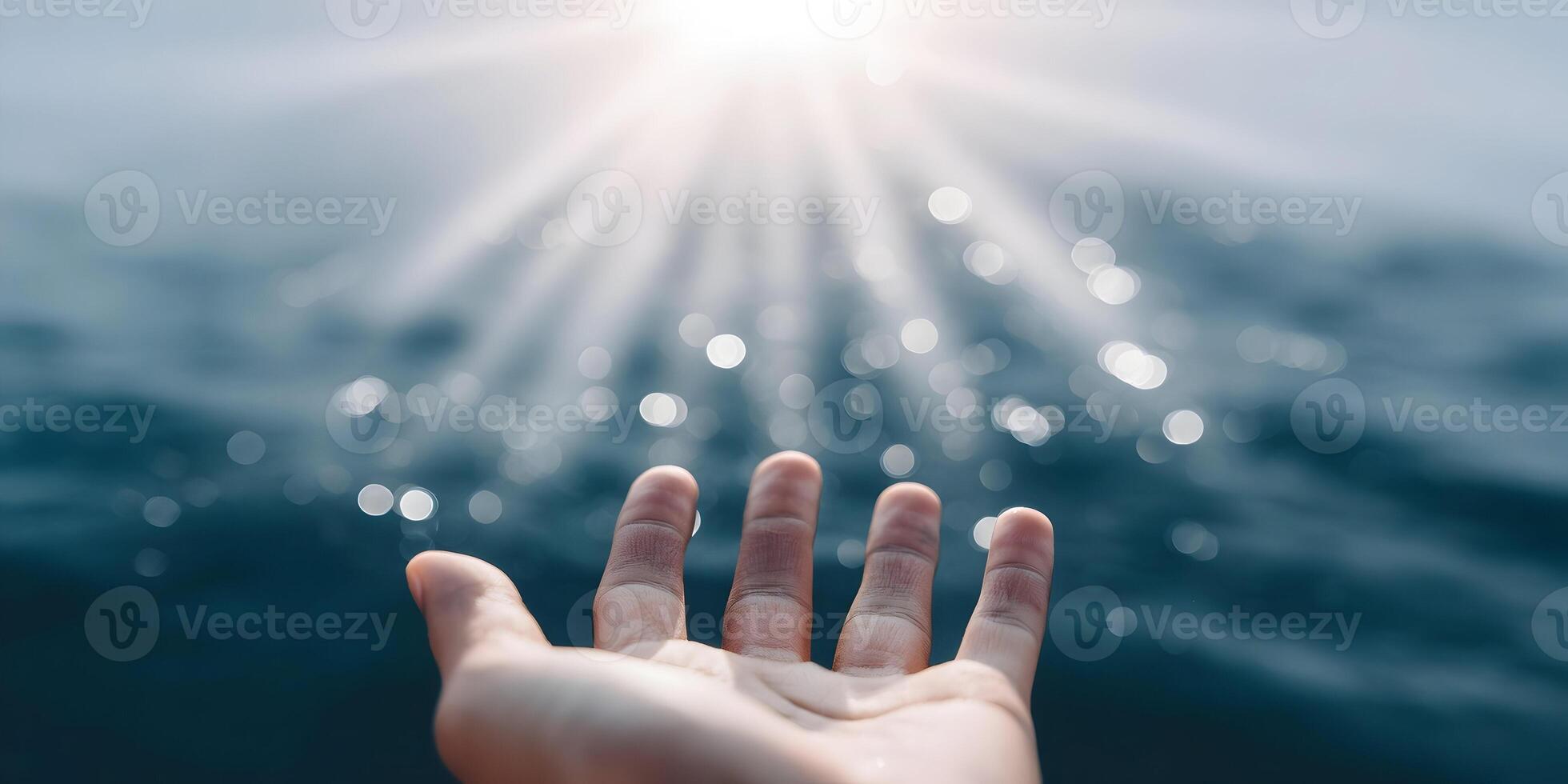Hand Reaching for Sunlight on Water Bokeh Background photo