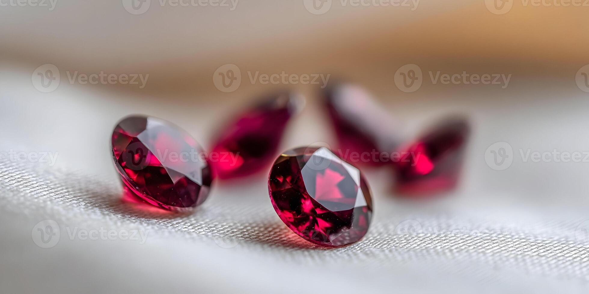 Closeup of Four Round Red Gemstones on White Fabric photo