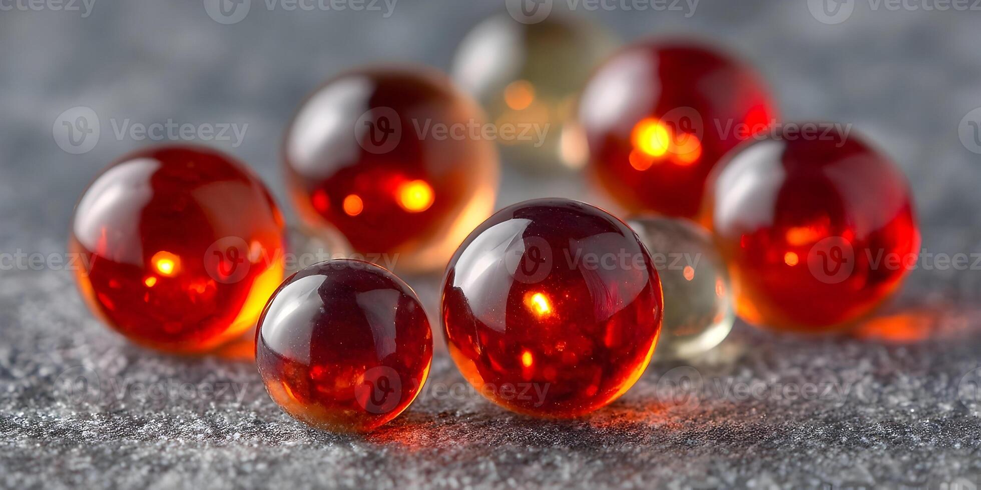 Glowing Red Glass Marbles on Gray Surface Closeup Photography photo
