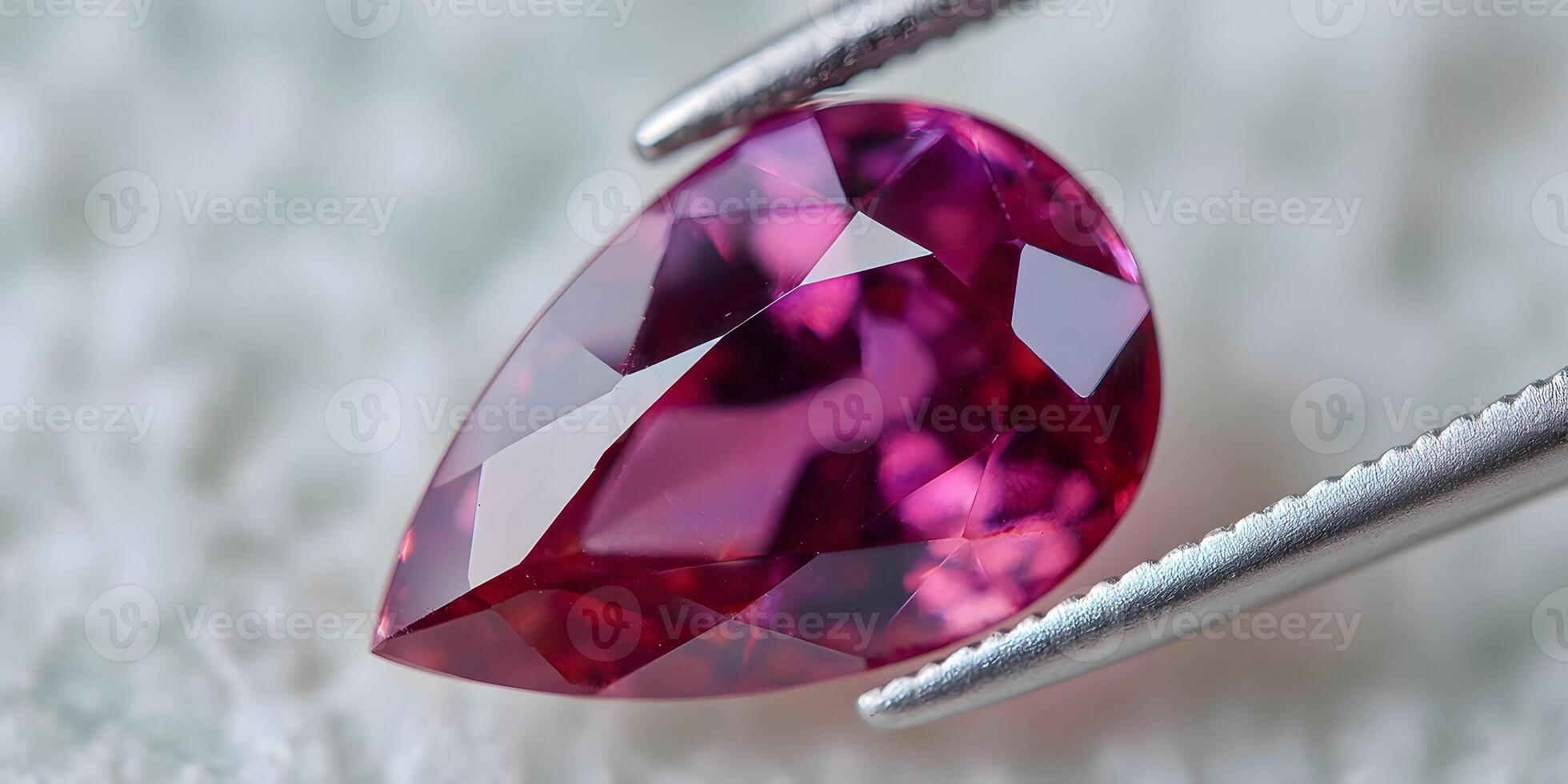 Closeup of Pink Pear Shaped Gemstone in Tweezers photo