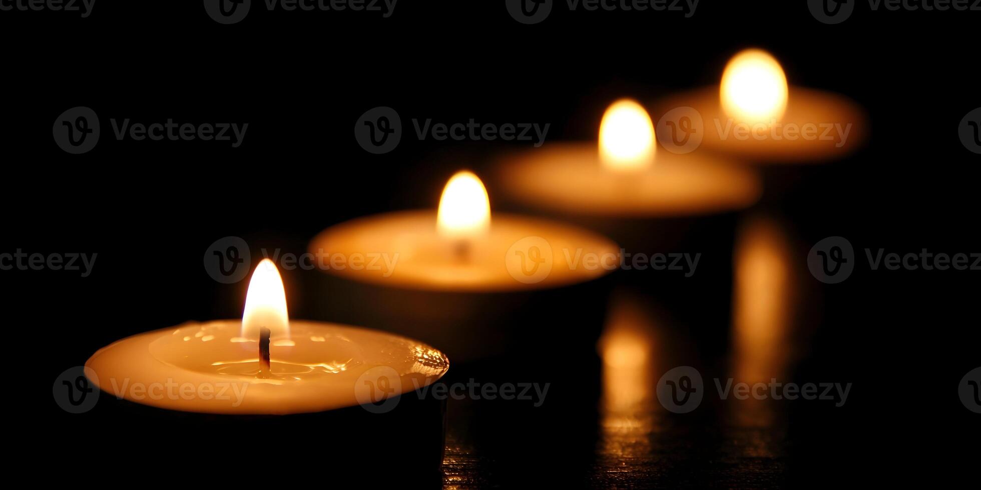 Four Lit Candles in a Row Dark Background Romantic Atmosphere photo