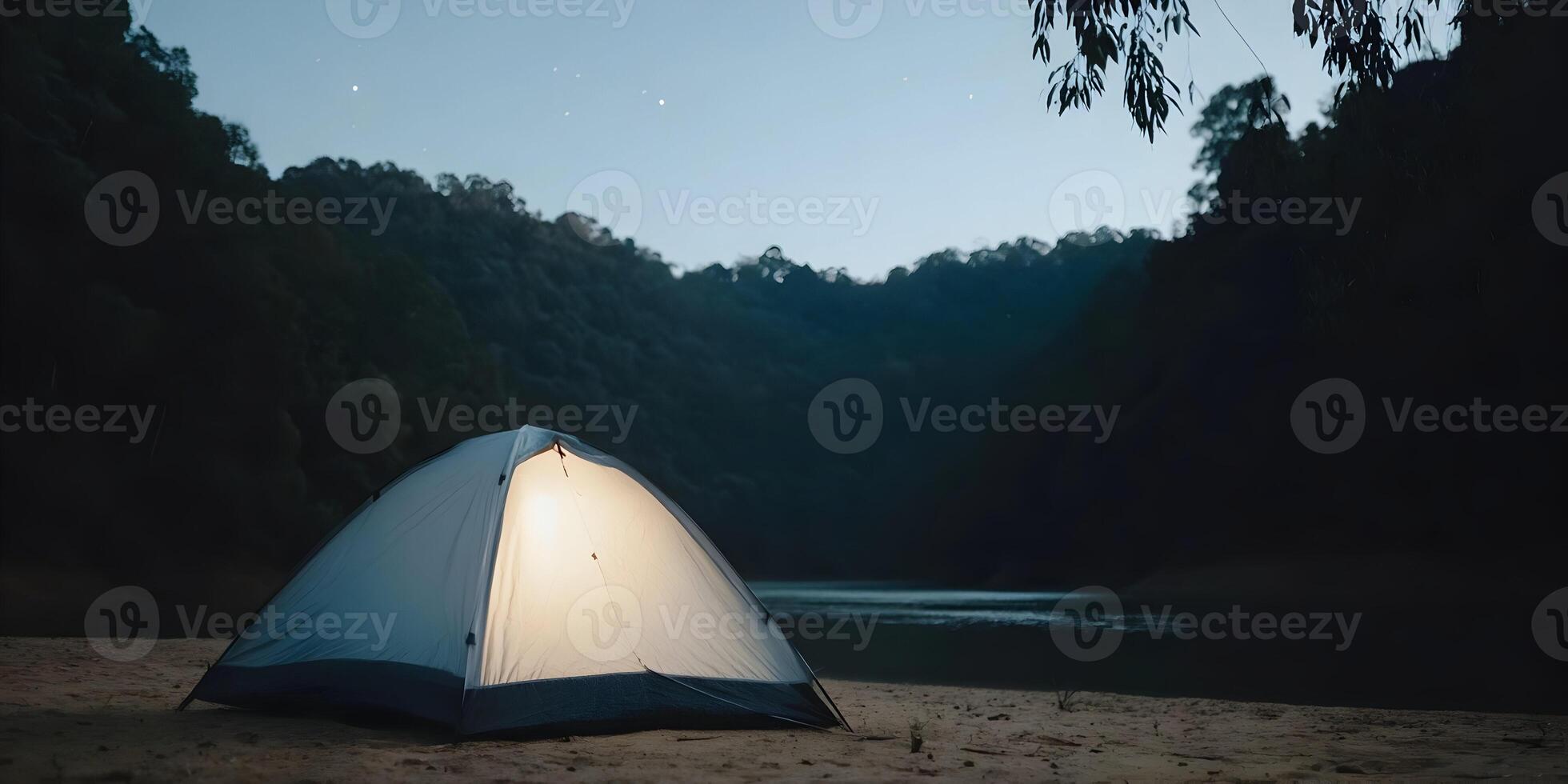 Illuminated Camping Tent on Sandy Beach at Night Dark Forest Lake Background photo