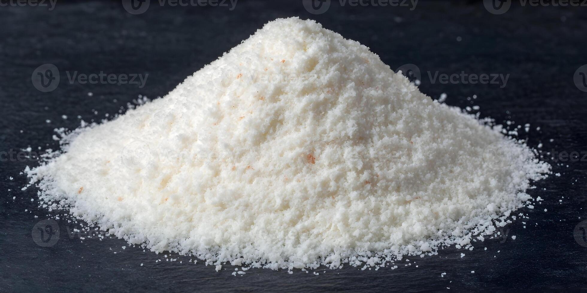 Pile of White Flaked Sea Salt on Dark Background photo