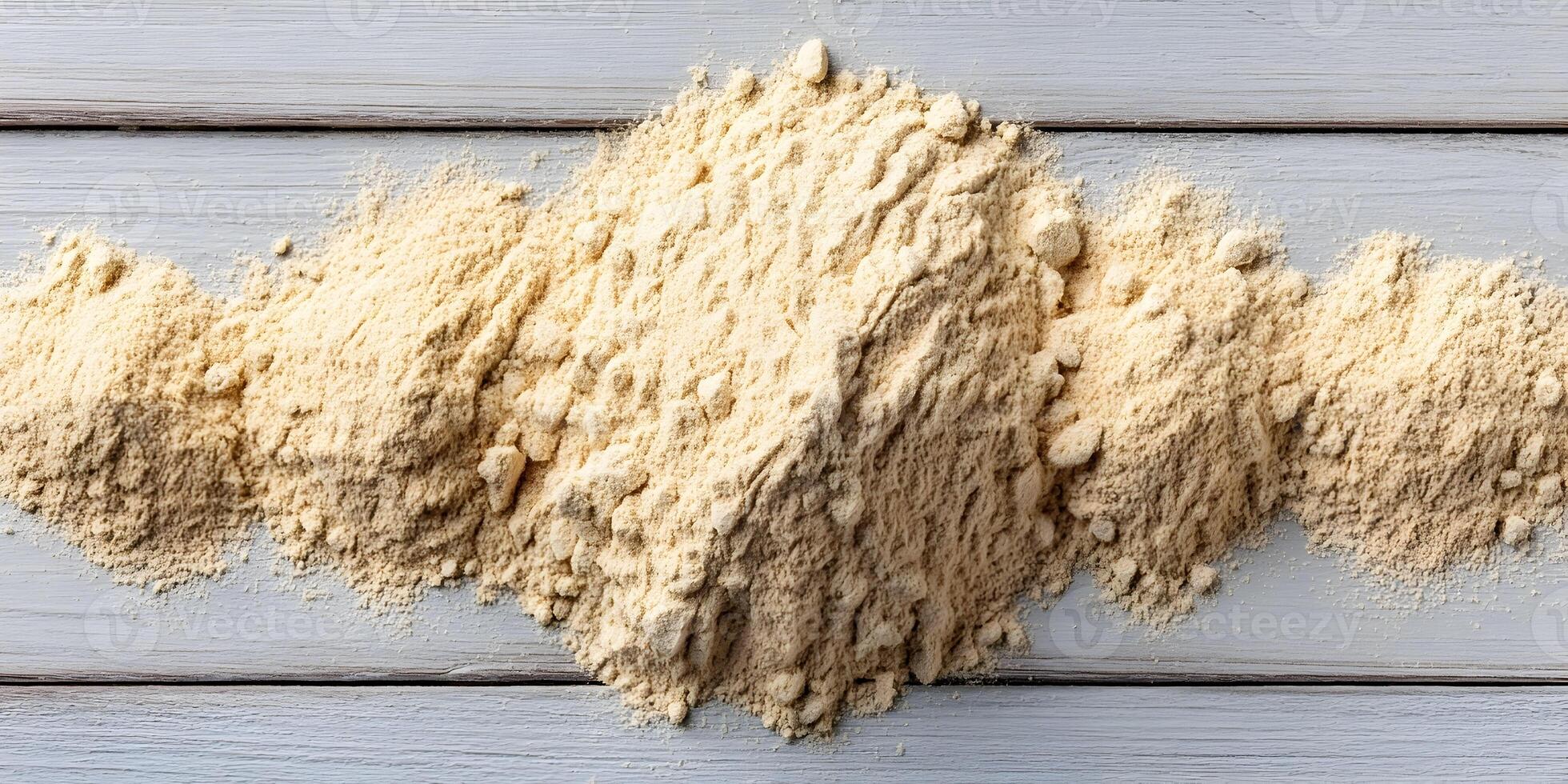 Top View Light Beige Maca Powder Pile on Wooden Table photo