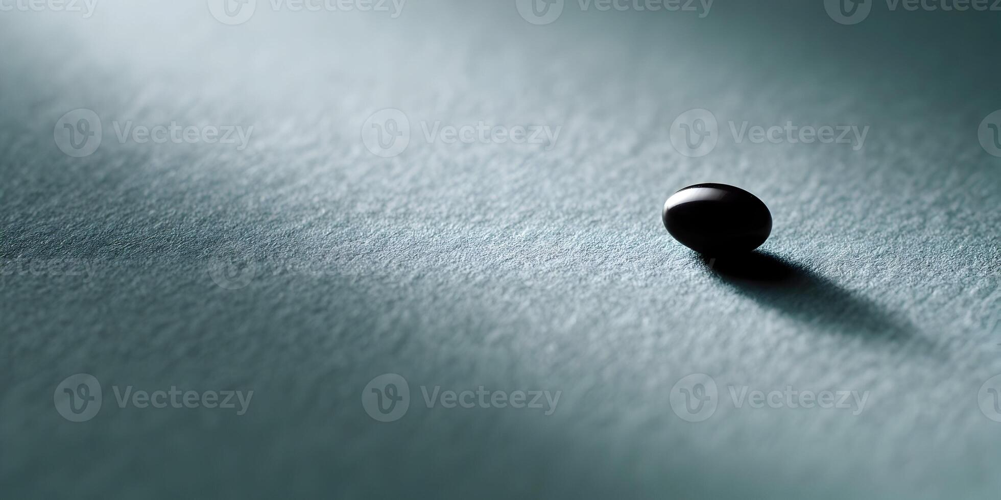 Single Dark Sphere on Teal Textured Surface Minimalist Photography photo