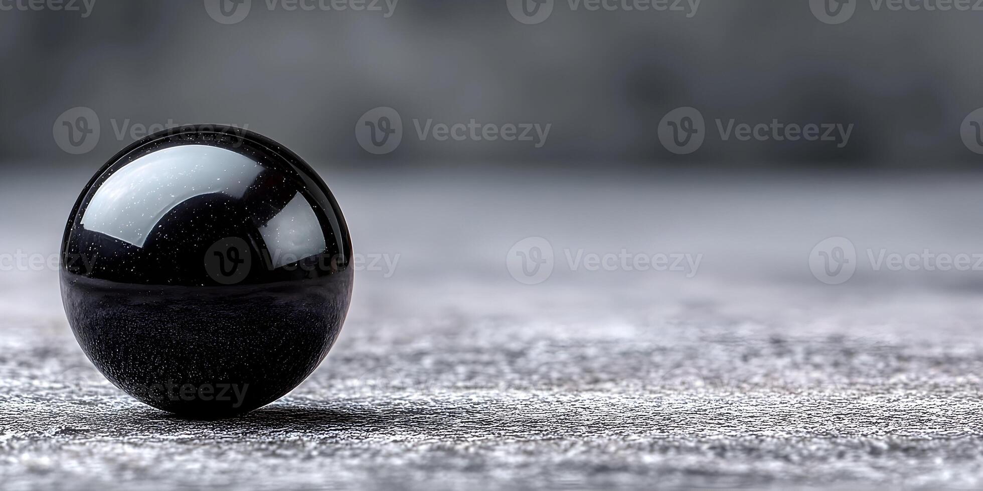 Black Sphere on Gray Textured Surface Closeup Photography photo