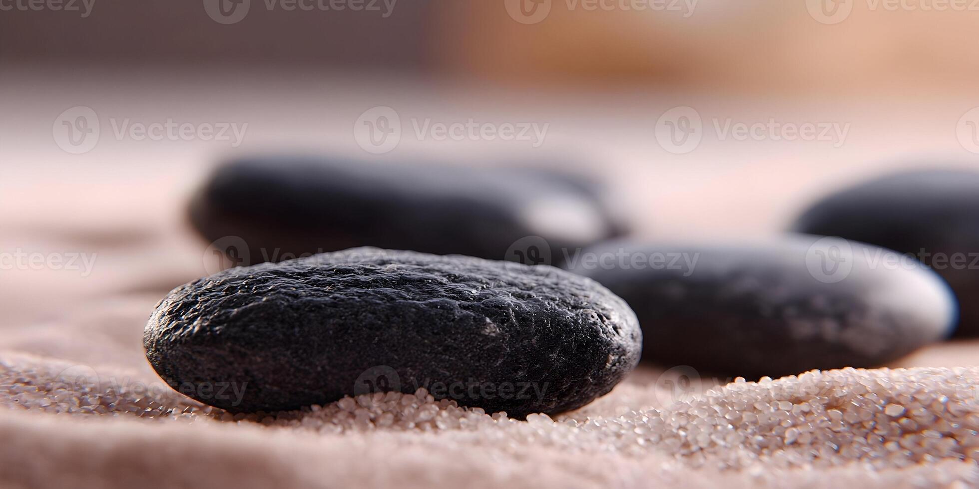 Closeup Dark Grey Stones on Light Brown Sand Zen Garden Spa Relaxation photo