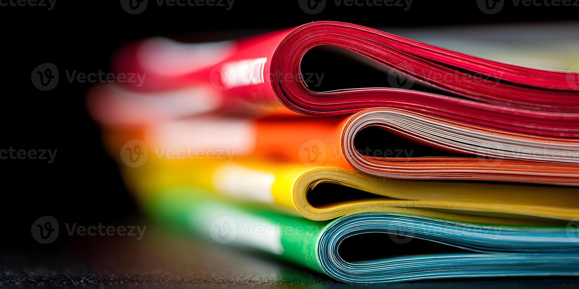 Colorful Stack of Magazines Closeup Rainbow Pages Red Orange Yellow Green Blue photo