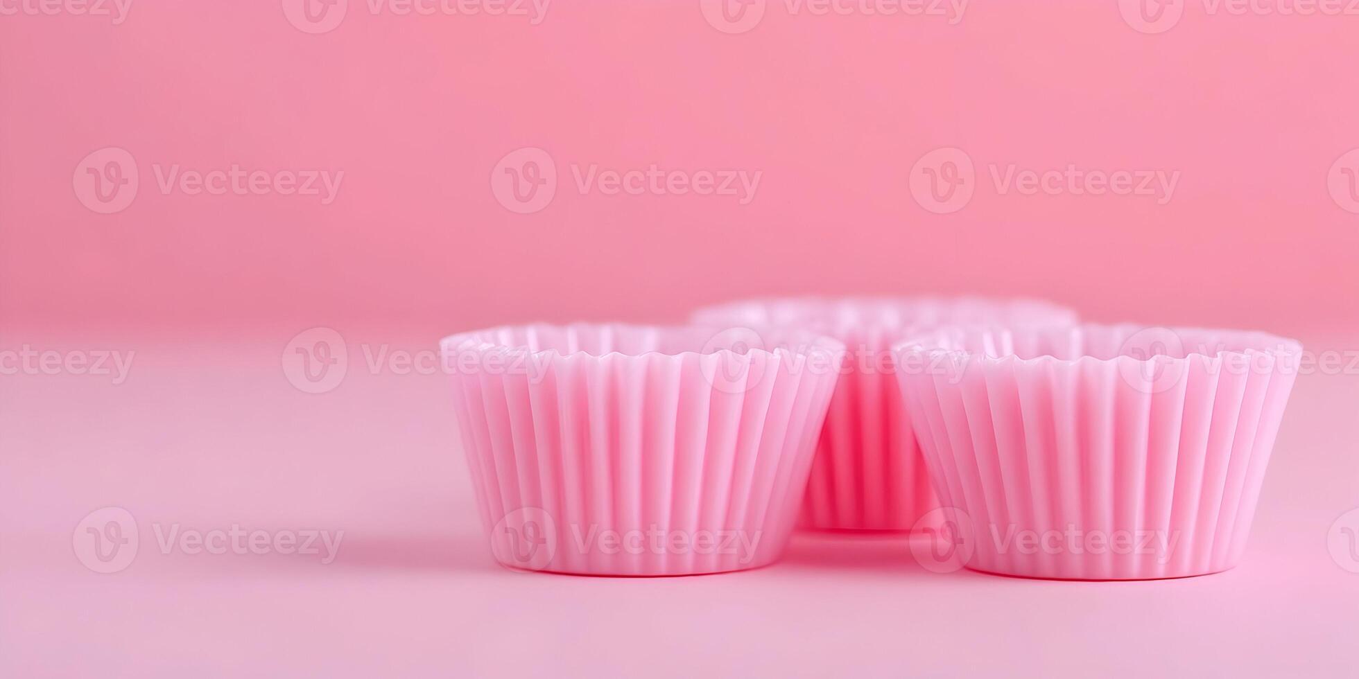 Pink Silicone Cupcake Liners Baking Cups on Pink Background photo