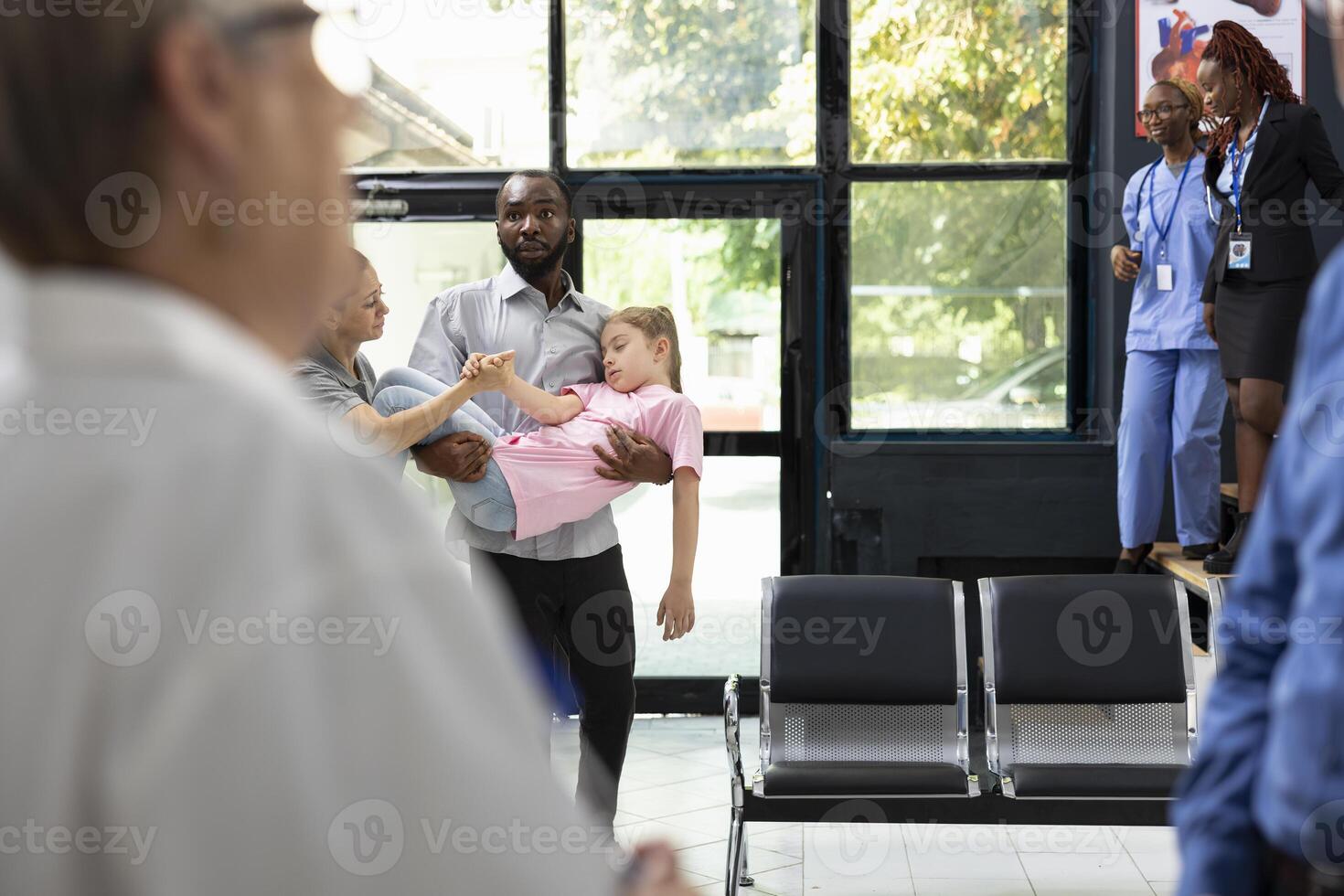 Concerned family members react to unconscious daughter in hospital setting, relying on professional healthcare staff for crisis treatment and urgent life saving attention. Emergency. photo