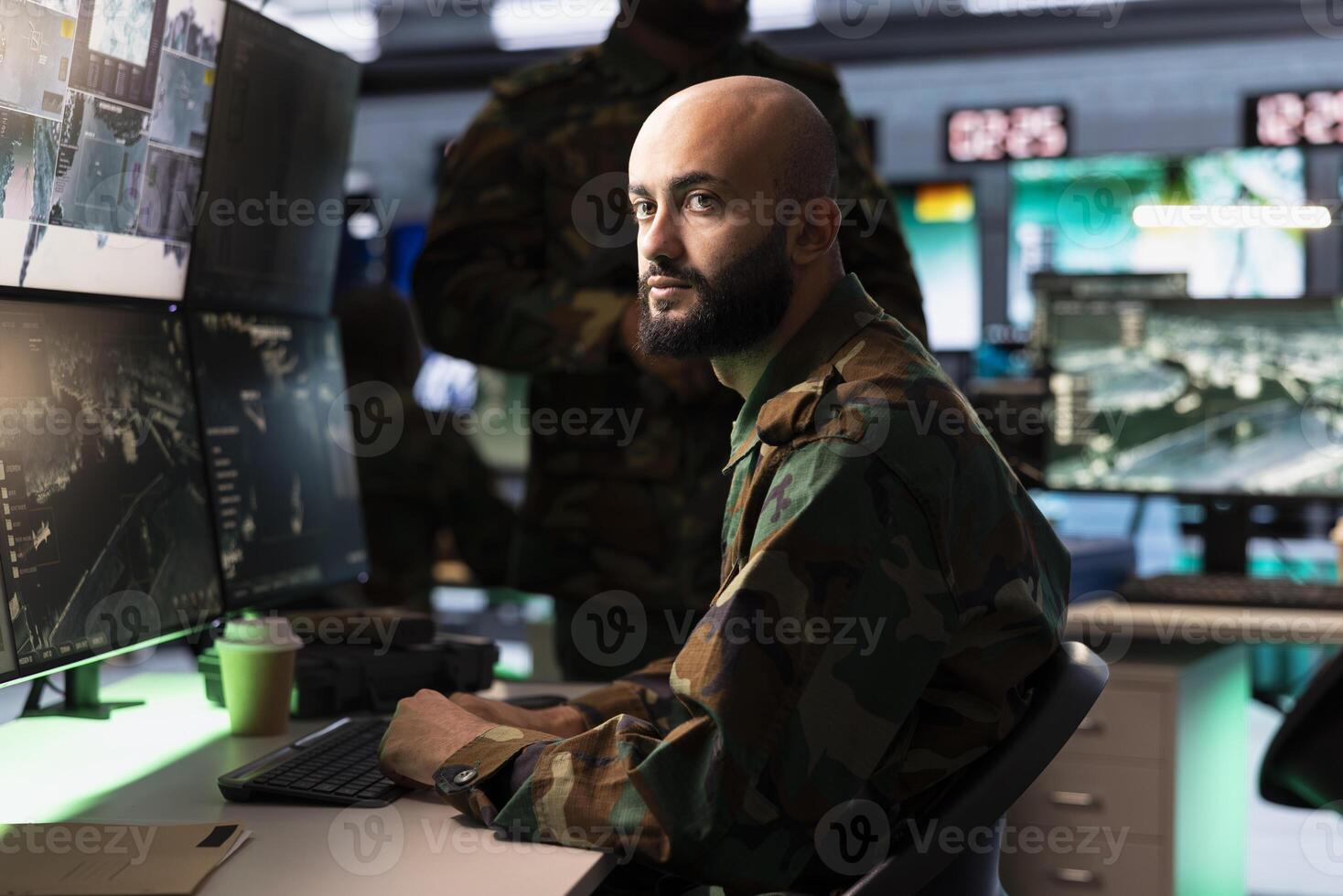 Intelligence corps agent working in command center housing operational missile defense system designed to intercept ballistic rockets. Middle Eastern man tracking missiles using radar systems photo