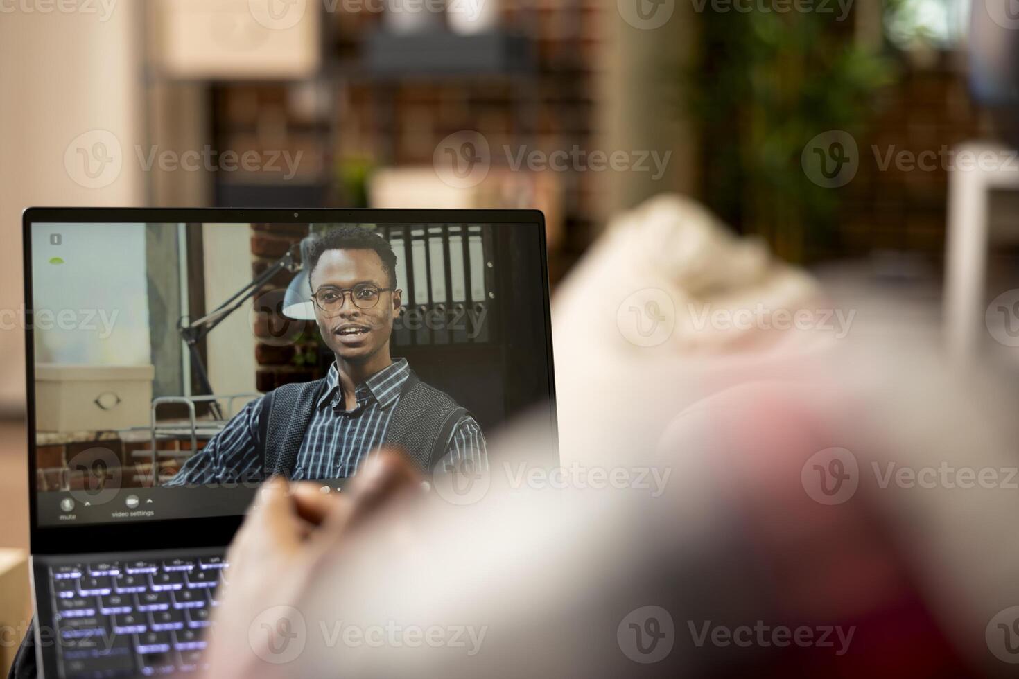 Remote worker speaks with company manager on call, discussing tasks and responsibilities of working from home. African american businessmen comparing marketing strategies during virtual meeting. photo