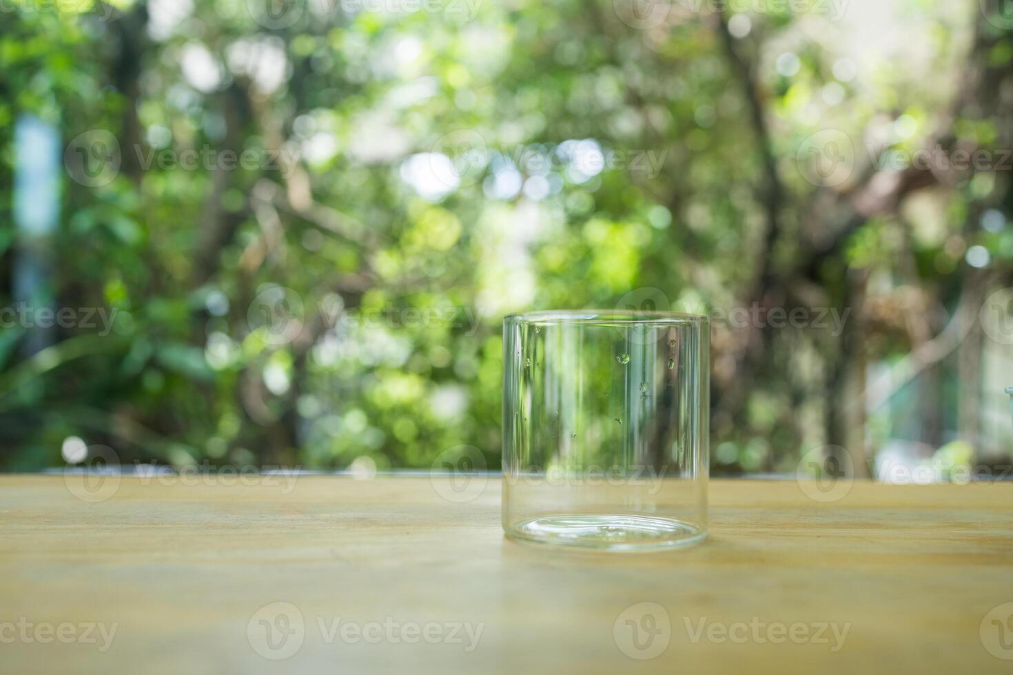 Empty glass ready to use placed on wood table photo