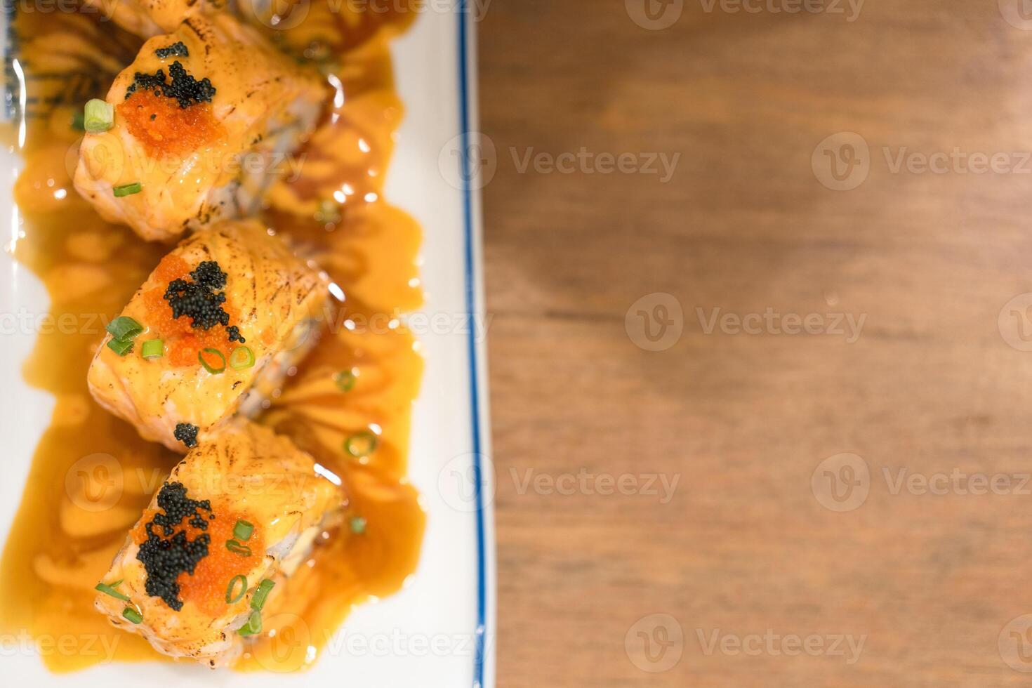 Delicious sushi salmon rolls topped with caviar photo